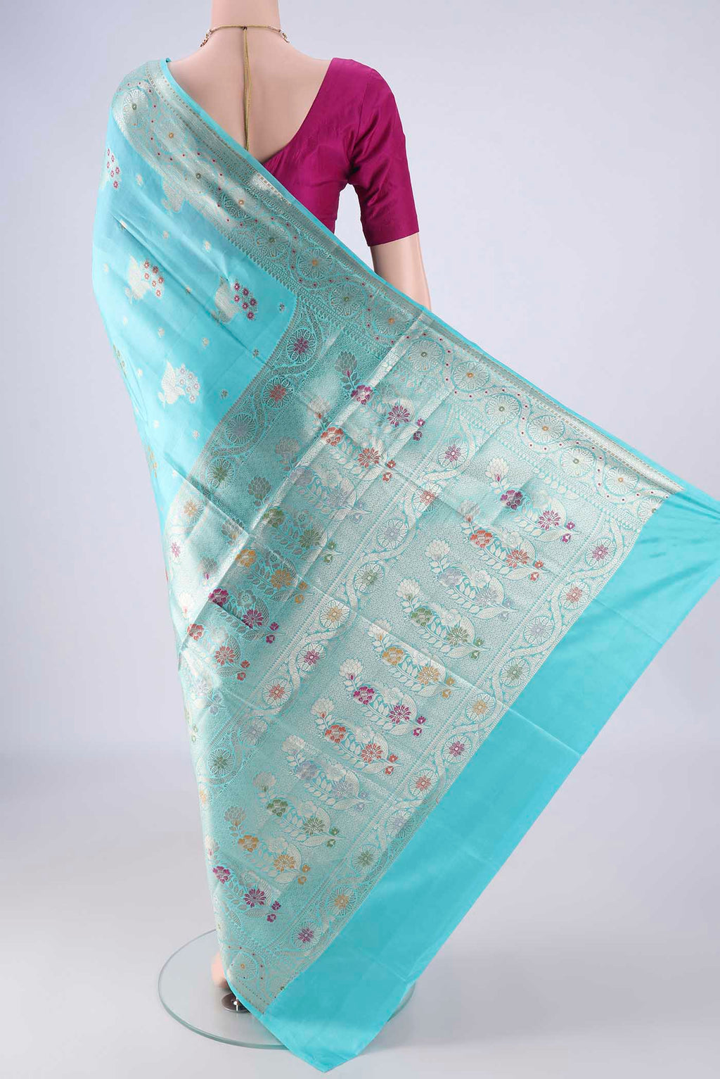 Flat view of Sky Blue Banarasi Raw Silk Saree with Zari And Thread Butta on the body and Zari And Thread Border. 