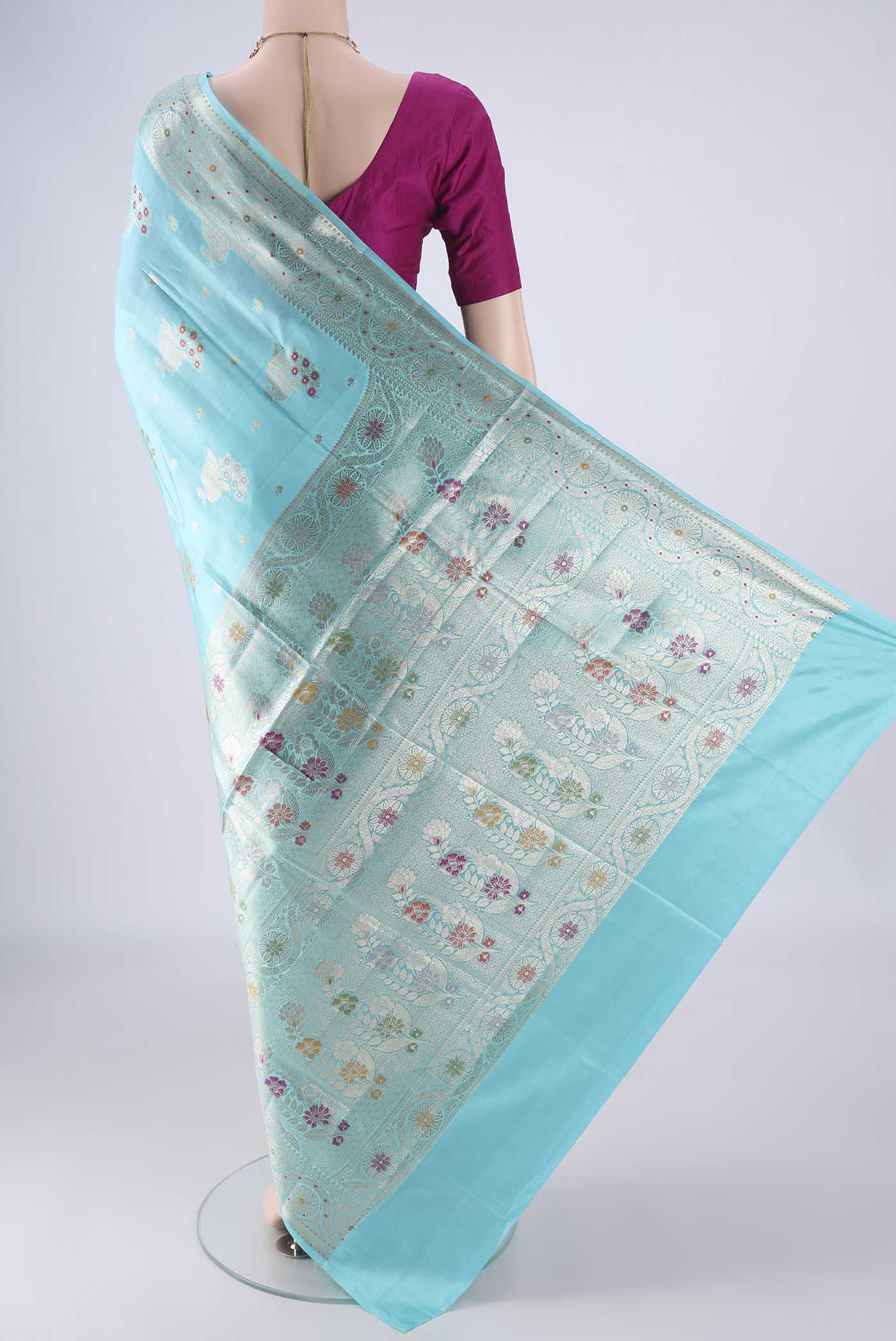 Flat view of Sky Blue Banarasi Raw Silk Saree with Zari And Thread Butta on the body and Zari And Thread Border. 
