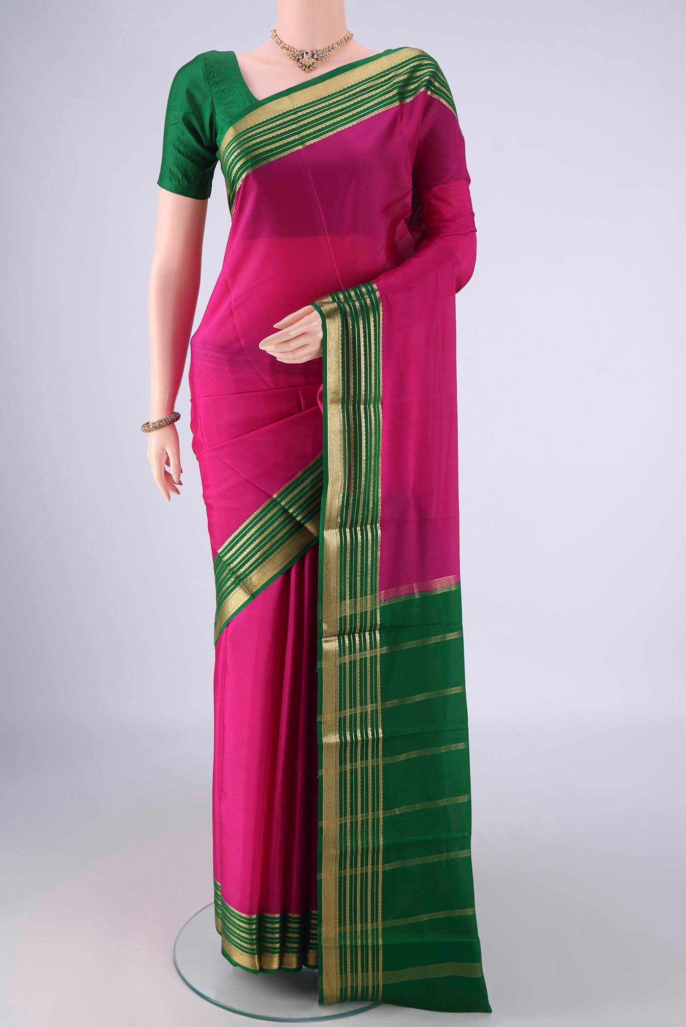 Rani Pink Mysore Crepe Saree with Plain Body and Zari Border.  displayed on a mannequin