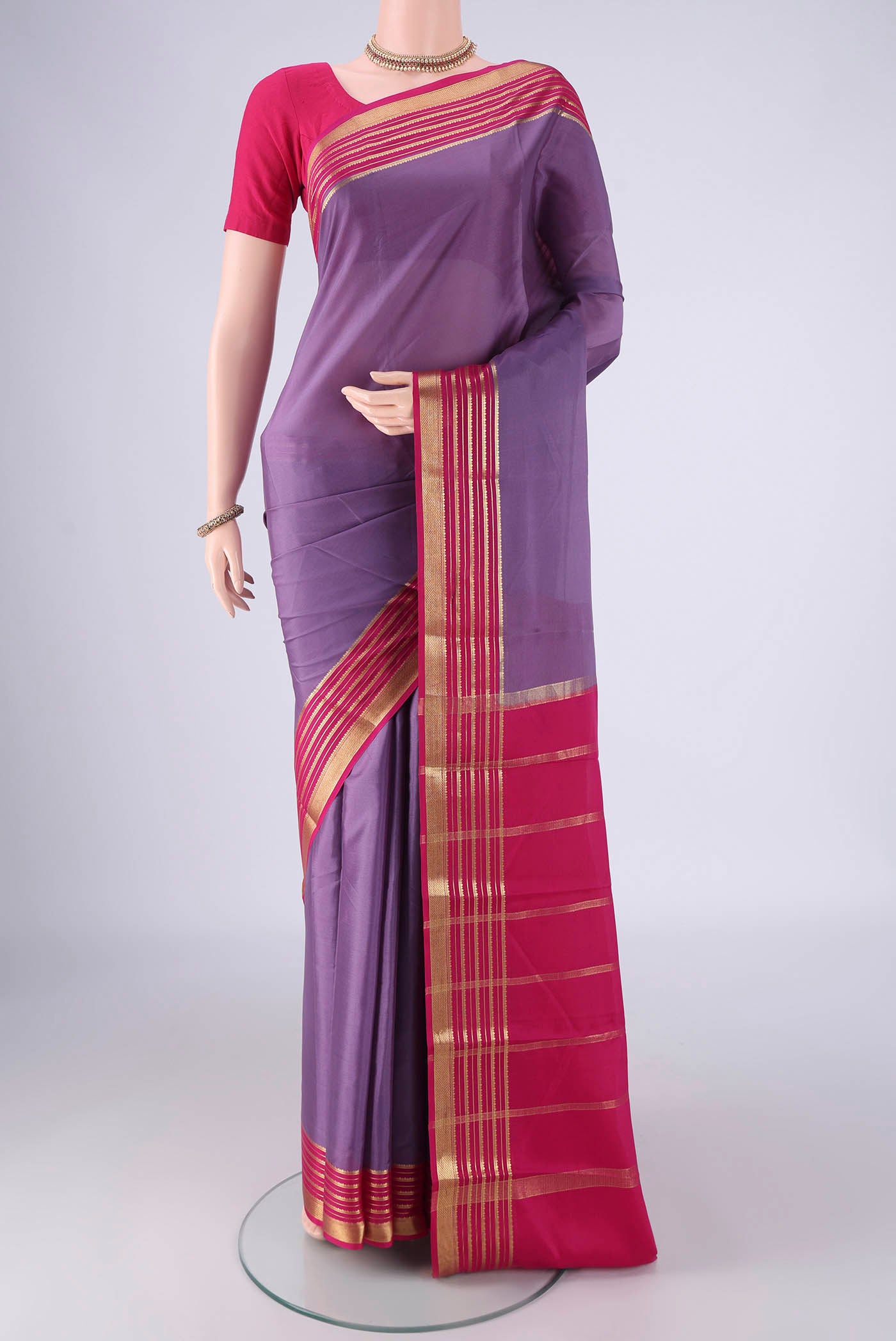 Lavender Mysore Crepe Saree with Plain Body and Zari Border.  displayed on a mannequin