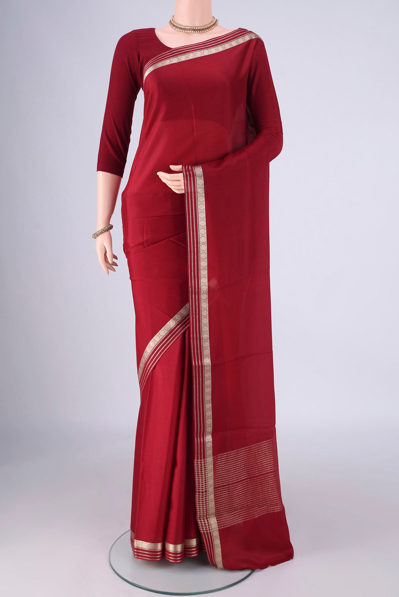Maroon Mysore Crepe Saree with Plain Body and Zari Border.  displayed on a mannequin
