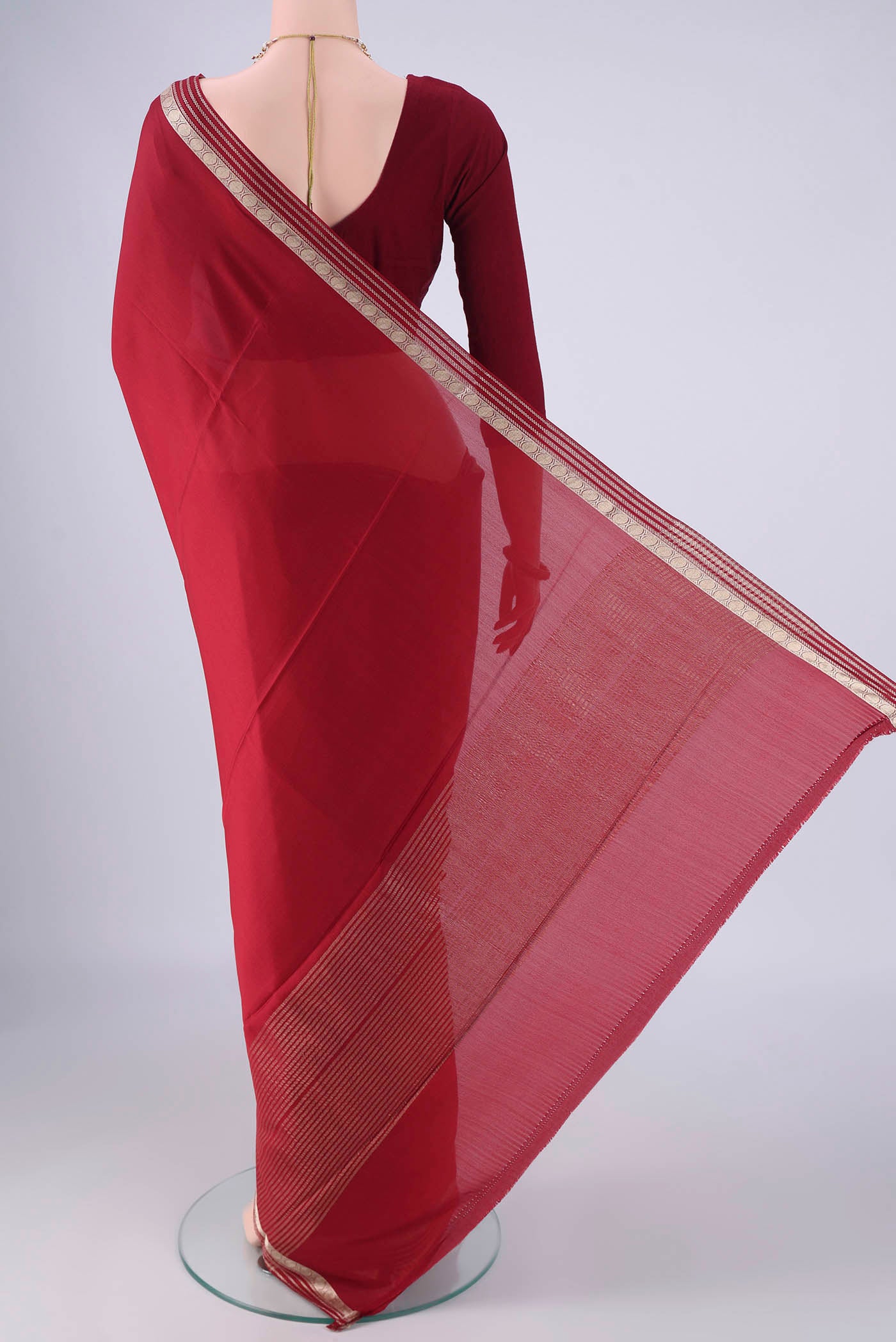 Flat view of Maroon Mysore Crepe Saree with Plain Body and Zari Border. 