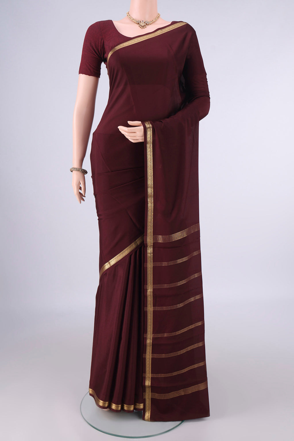 Coffee Brown Mysore Crepe Saree with Plain Body and Zari Border.  displayed on a mannequin