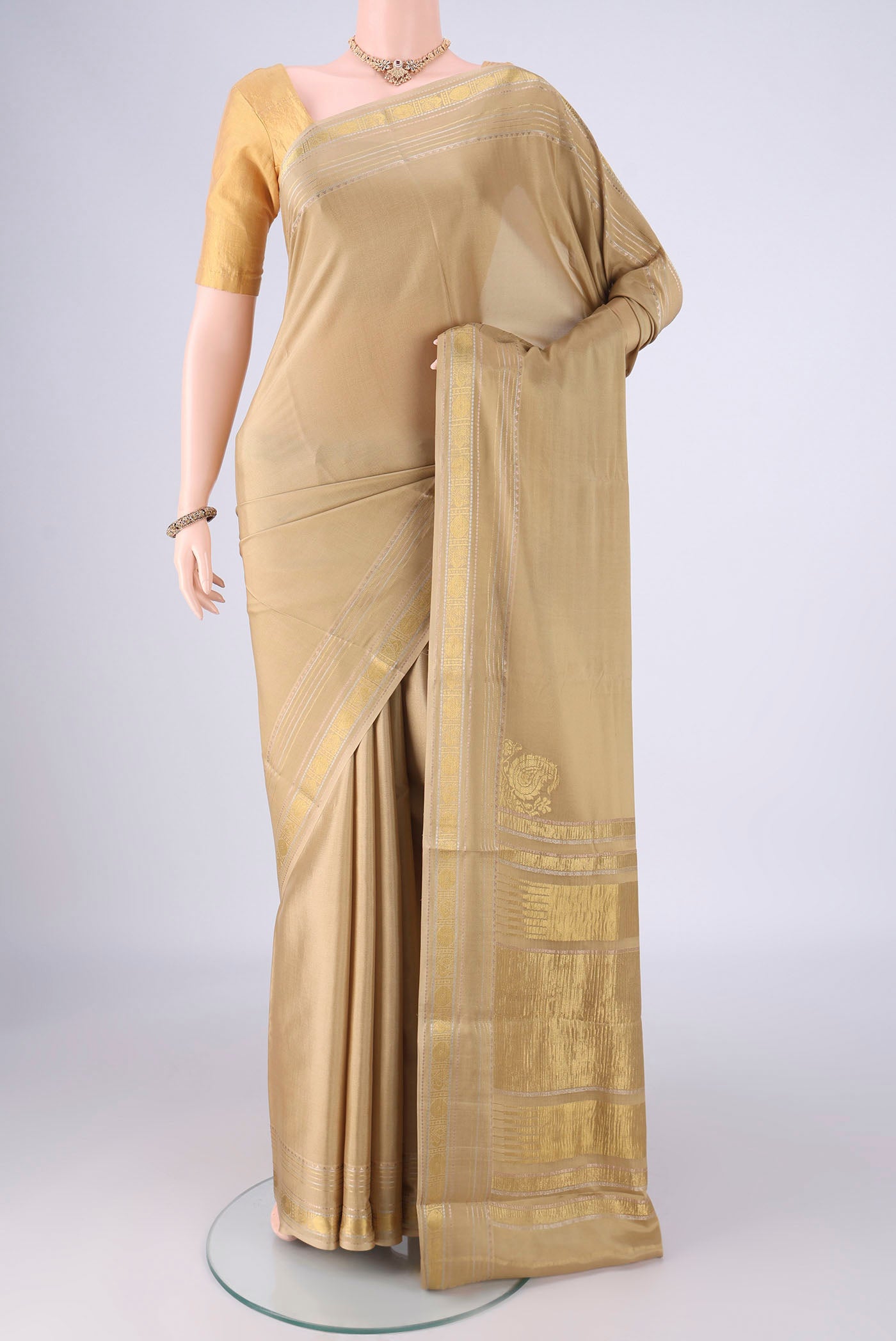 Beige Mysore Crepe Saree with Plain Body and Zari Border.  displayed on a mannequin