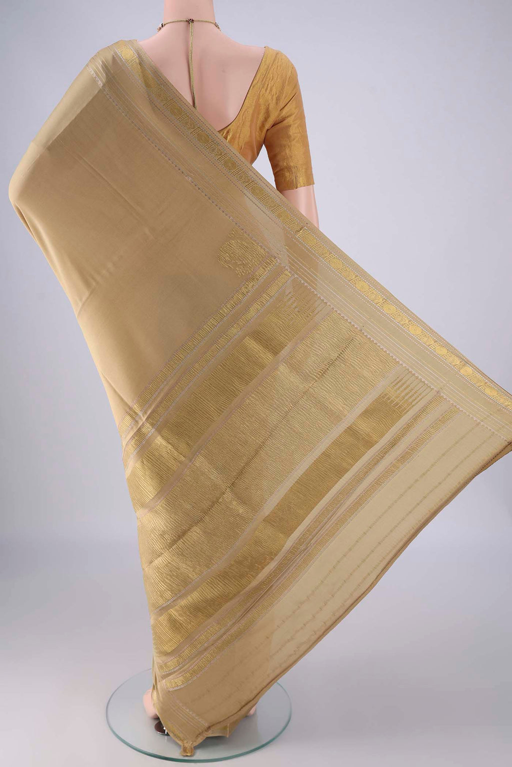 Flat view of Beige Mysore Crepe Saree with Plain Body and Zari Border. 