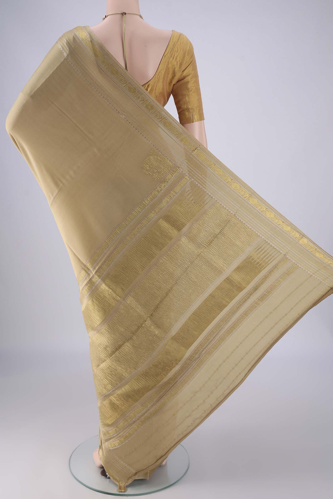 Flat view of Beige Mysore Crepe Saree with Plain Body and Zari Border. 