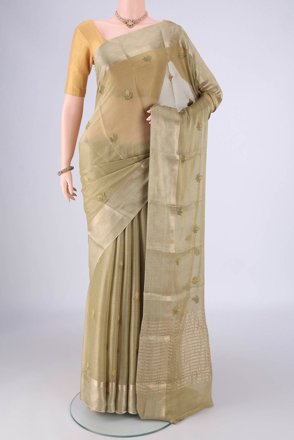 Beige Mysore Georgette Saree with Embroidery on the body and Zari Border.  displayed on a mannequin