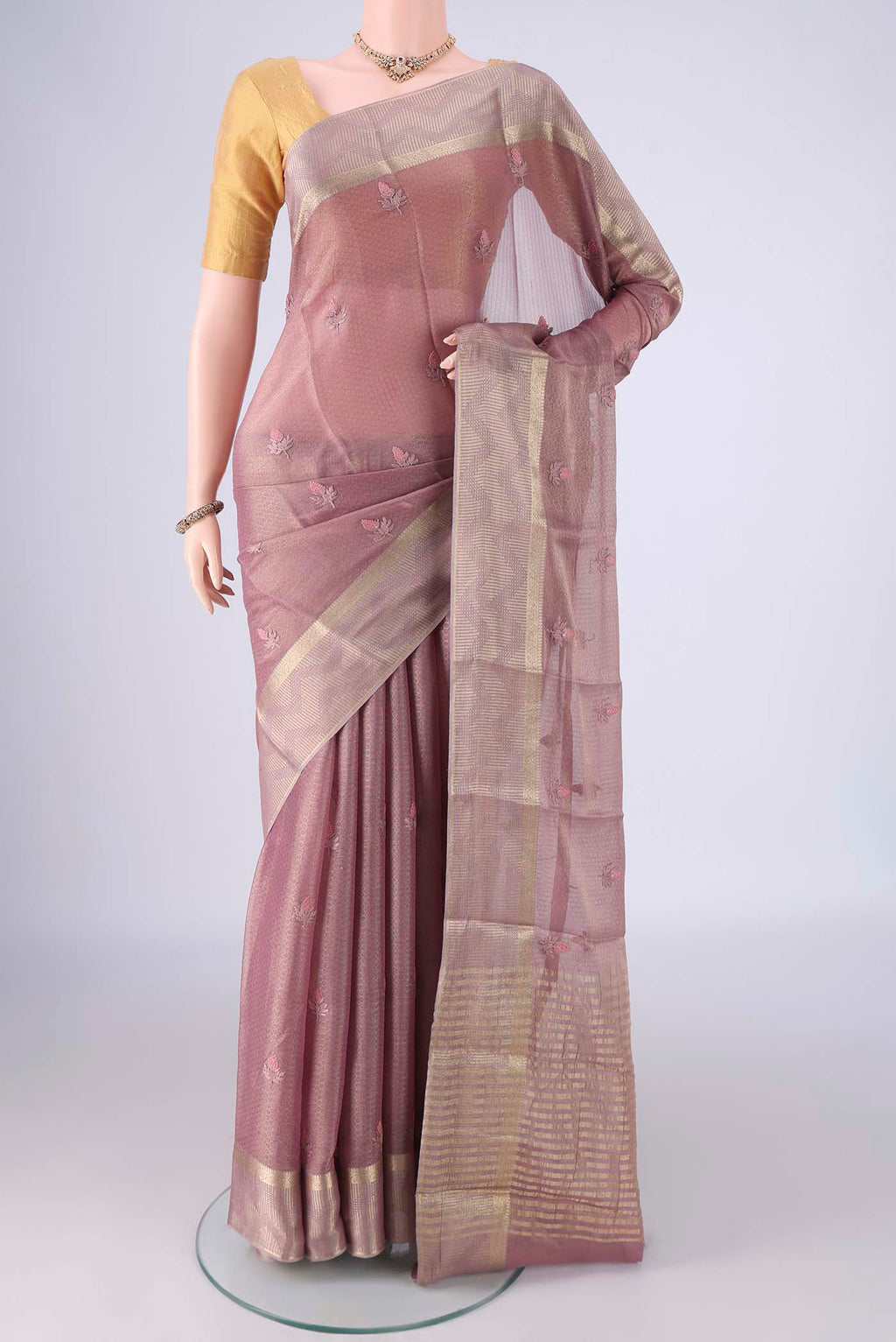 Mauve Mysore Georgette Saree with Embroidery on the body and Zari Border.  displayed on a mannequin