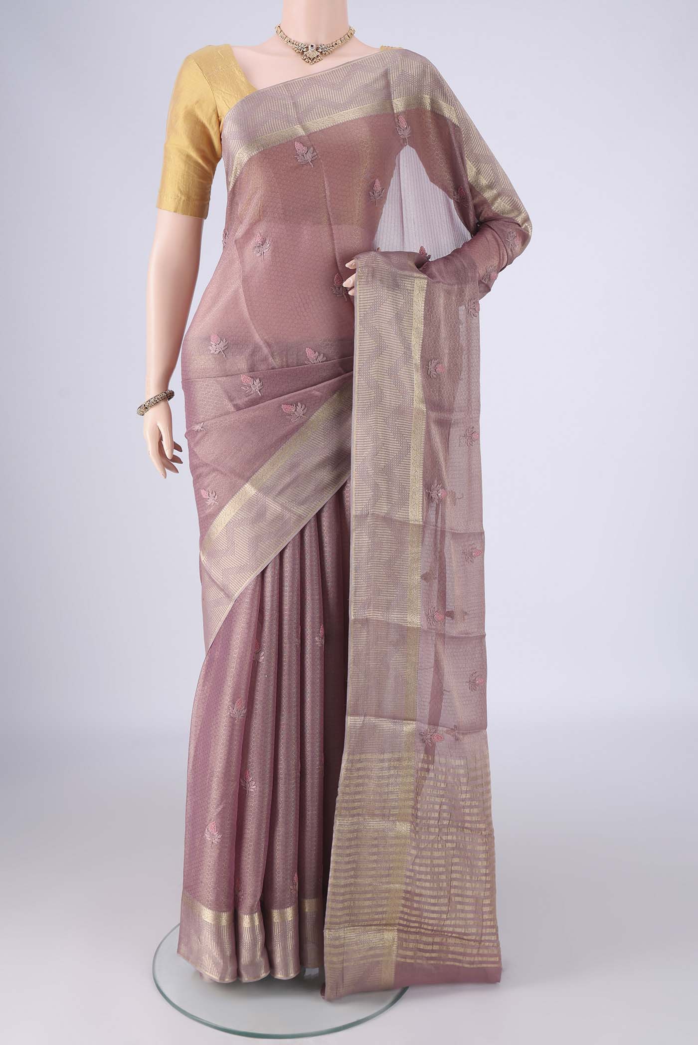 Mauve Mysore Georgette Saree with Embroidery on the body and Zari Border.  displayed on a mannequin