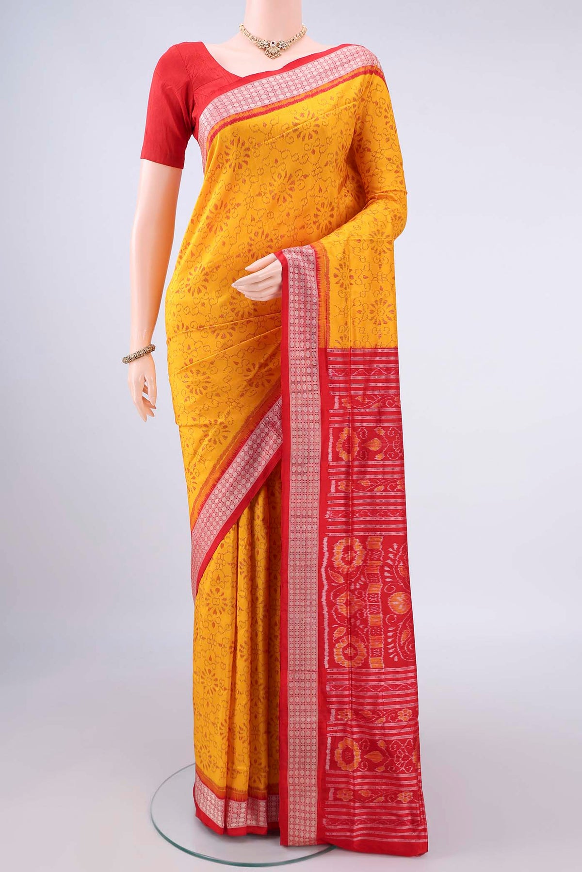 Pure Silk Yellow Orissa Saree with Pure Ikat on the body and Thread Border.  displayed on a mannequin
