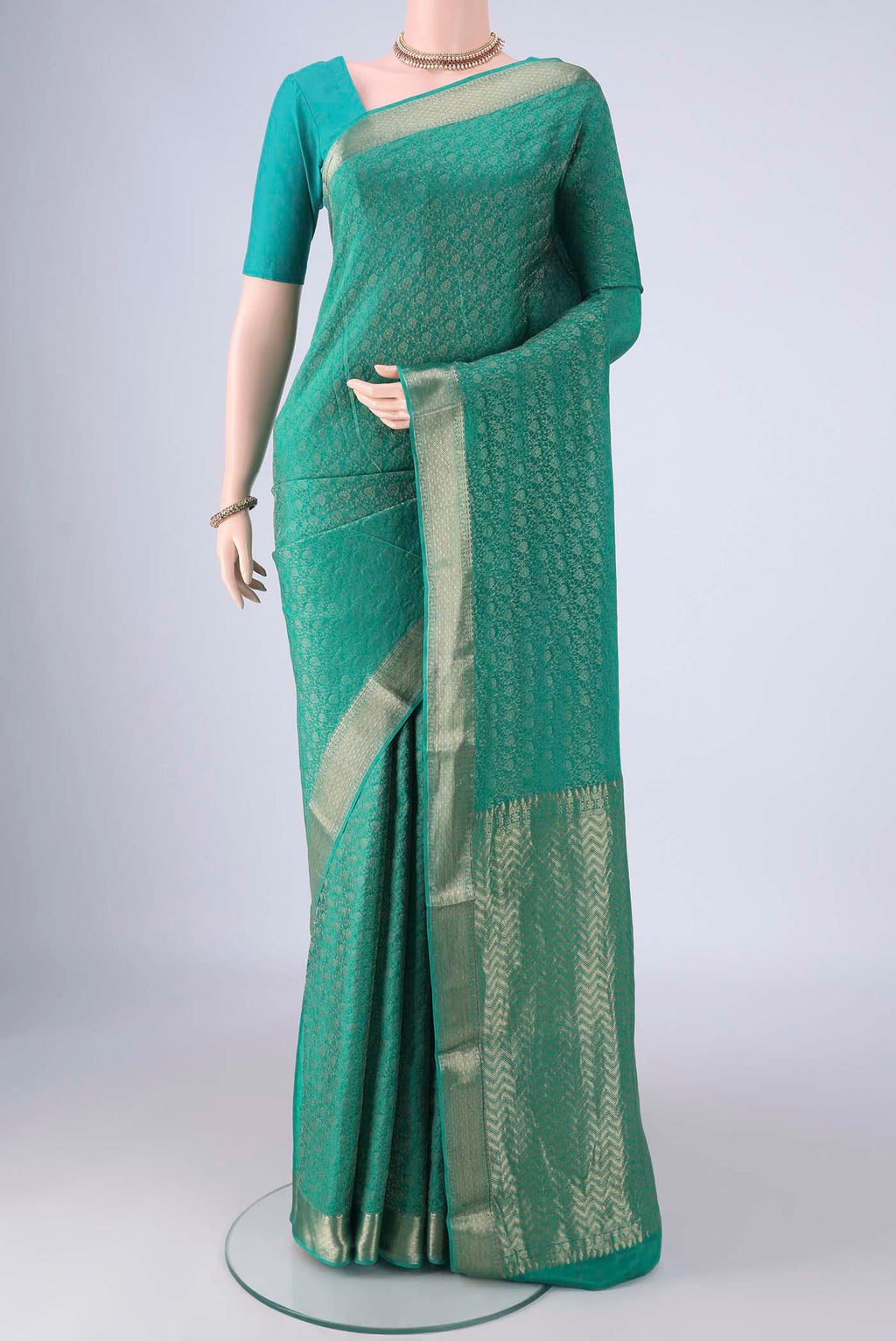 Turquoise Mysore Crepe Saree with Zari Brocade on the body and Zari Border.  displayed on a mannequin