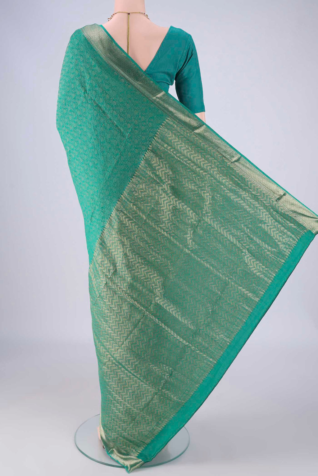 Flat view of Turquoise Mysore Crepe Saree with Zari Brocade on the body and Zari Border. 