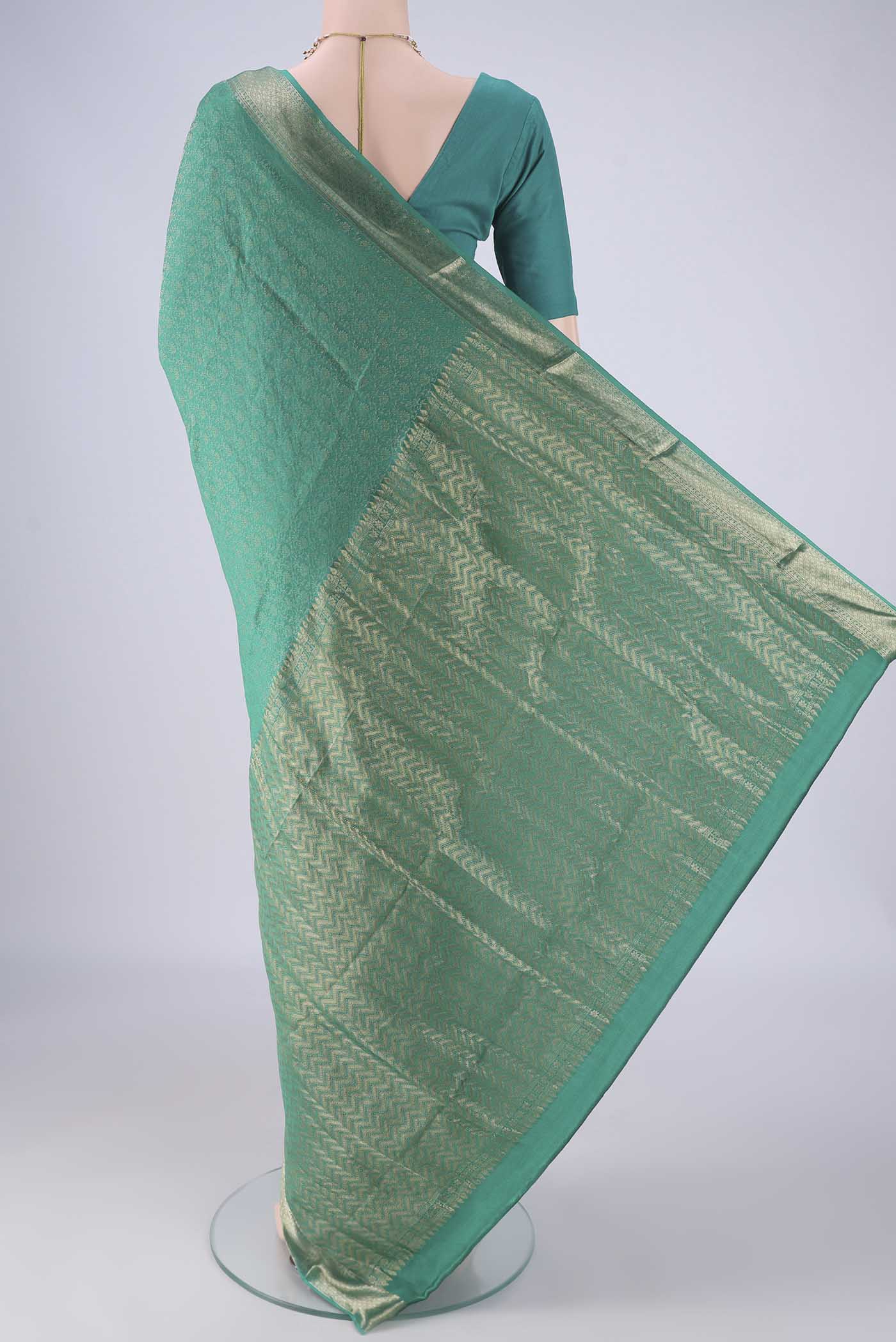 Flat view of Turquoise Mysore Crepe Saree with Zari Brocade on the body and Zari Border. 