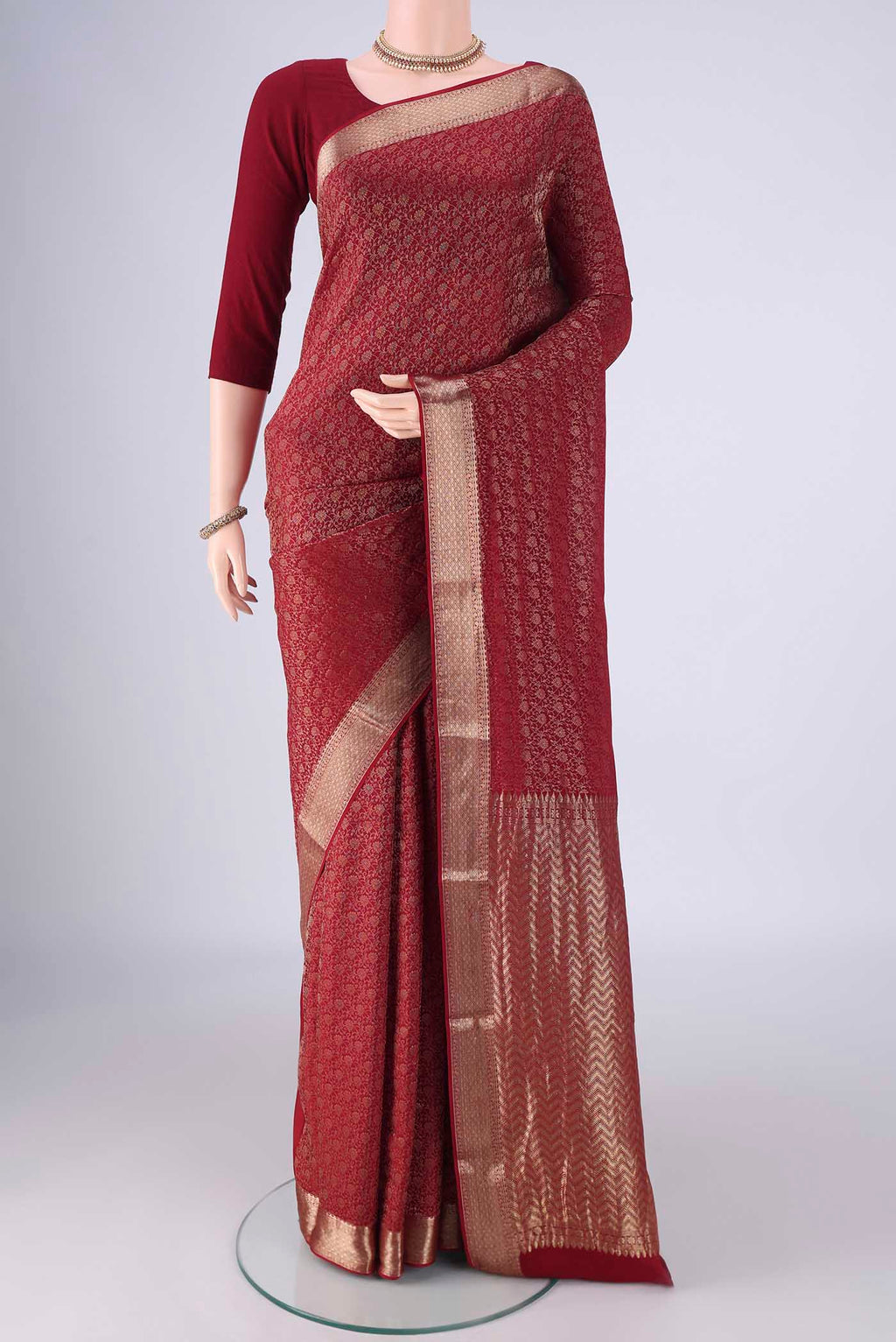 Maroon Mysore Crepe Saree with Zari Brocade on the body and Zari Border.  displayed on a mannequin