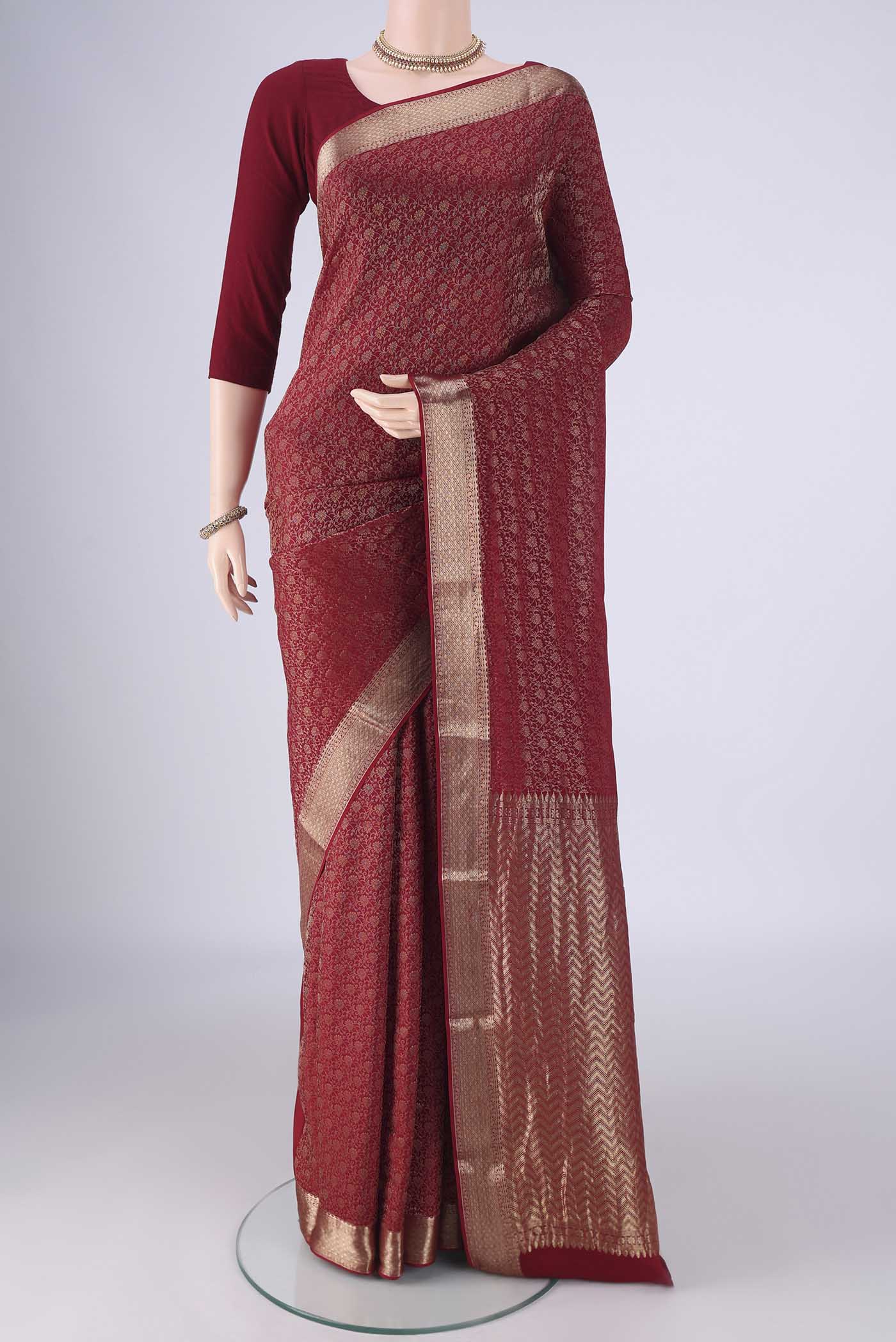 Maroon Mysore Crepe Saree with Zari Brocade on the body and Zari Border.  displayed on a mannequin