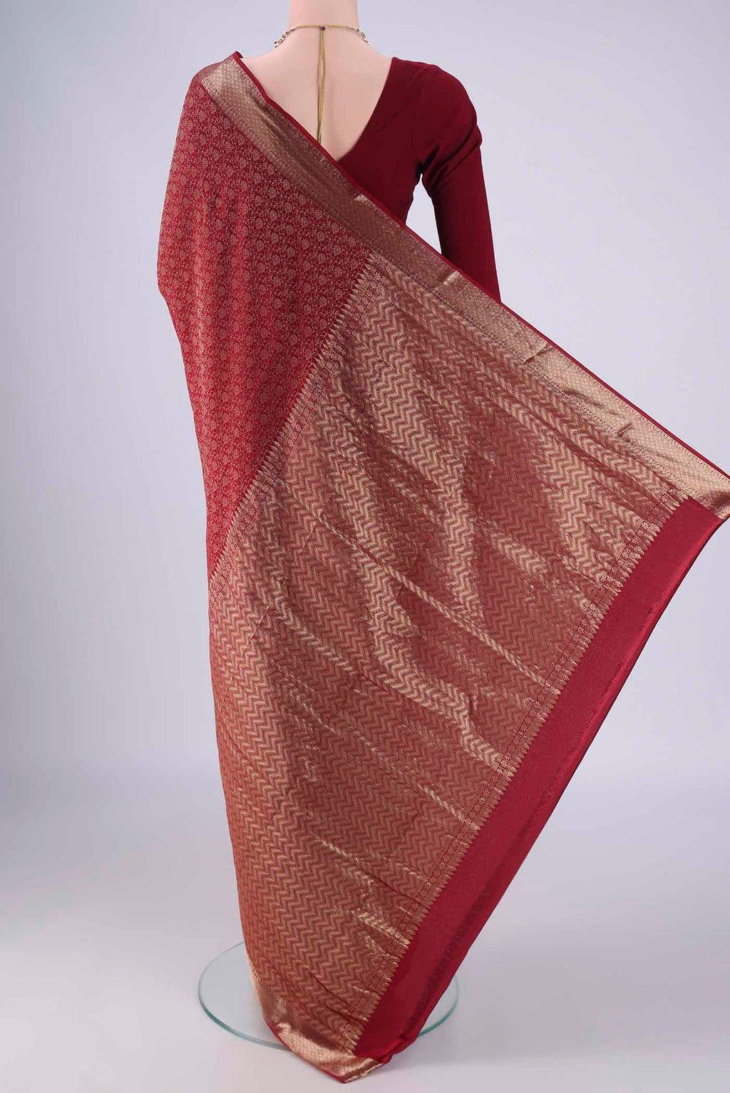 Flat view of Maroon Mysore Crepe Saree with Zari Brocade on the body and Zari Border. 