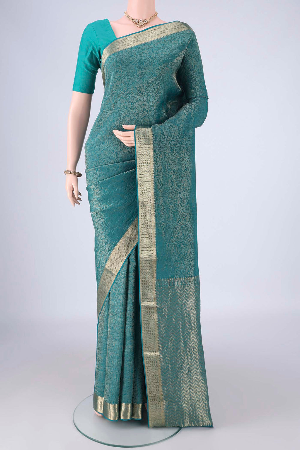Peacock Blue Mysore Crepe Saree with Zari Brocade on the body and Zari Border.  displayed on a mannequin