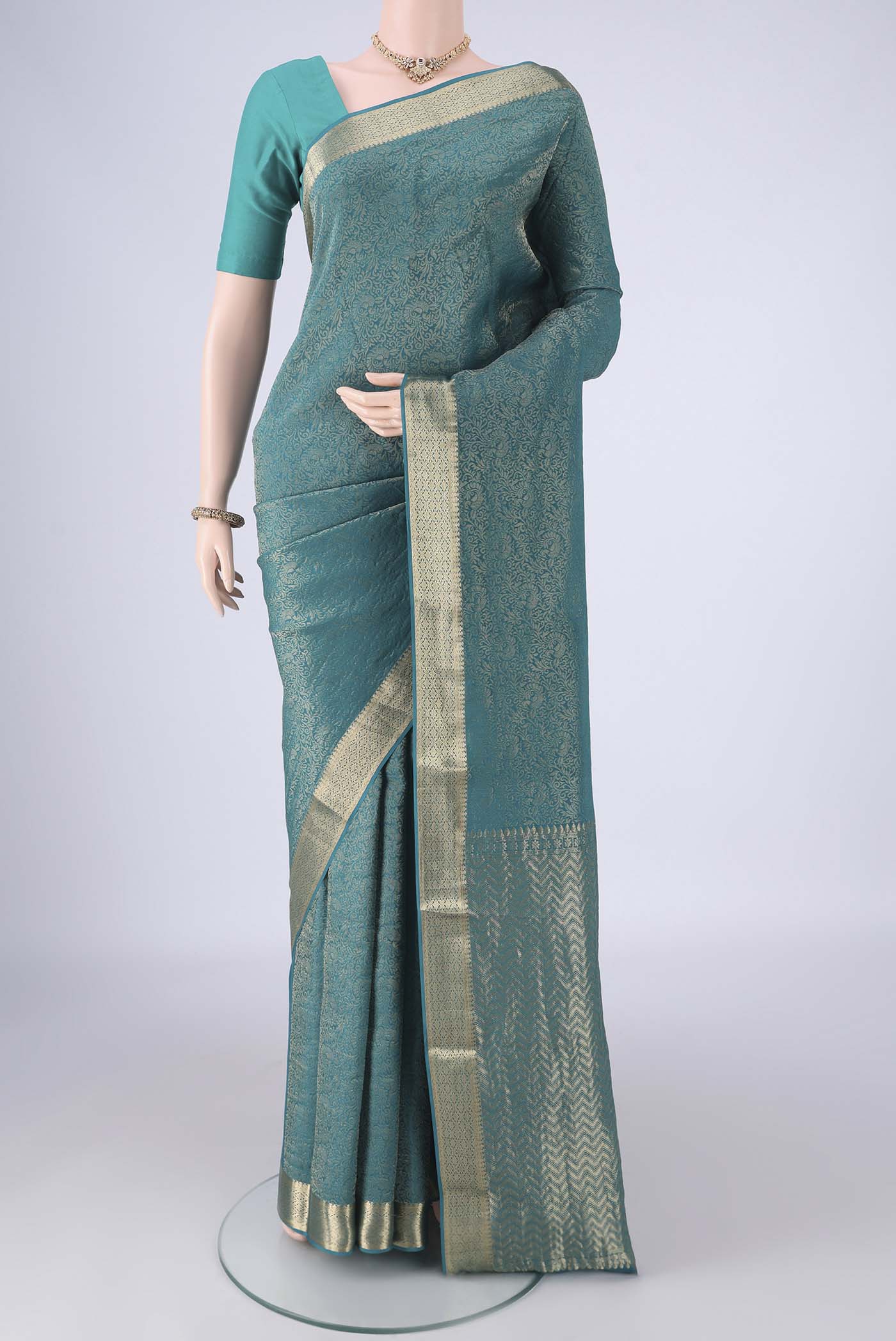 Peacock Blue Mysore Crepe Saree with Zari Brocade on the body and Zari Border.  displayed on a mannequin