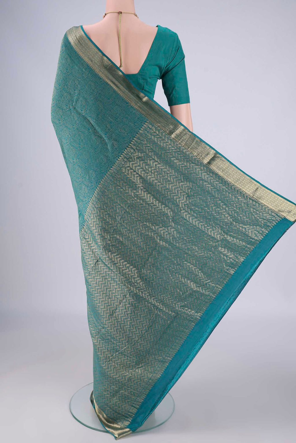 Flat view of Peacock Blue Mysore Crepe Saree with Zari Brocade on the body and Zari Border. 