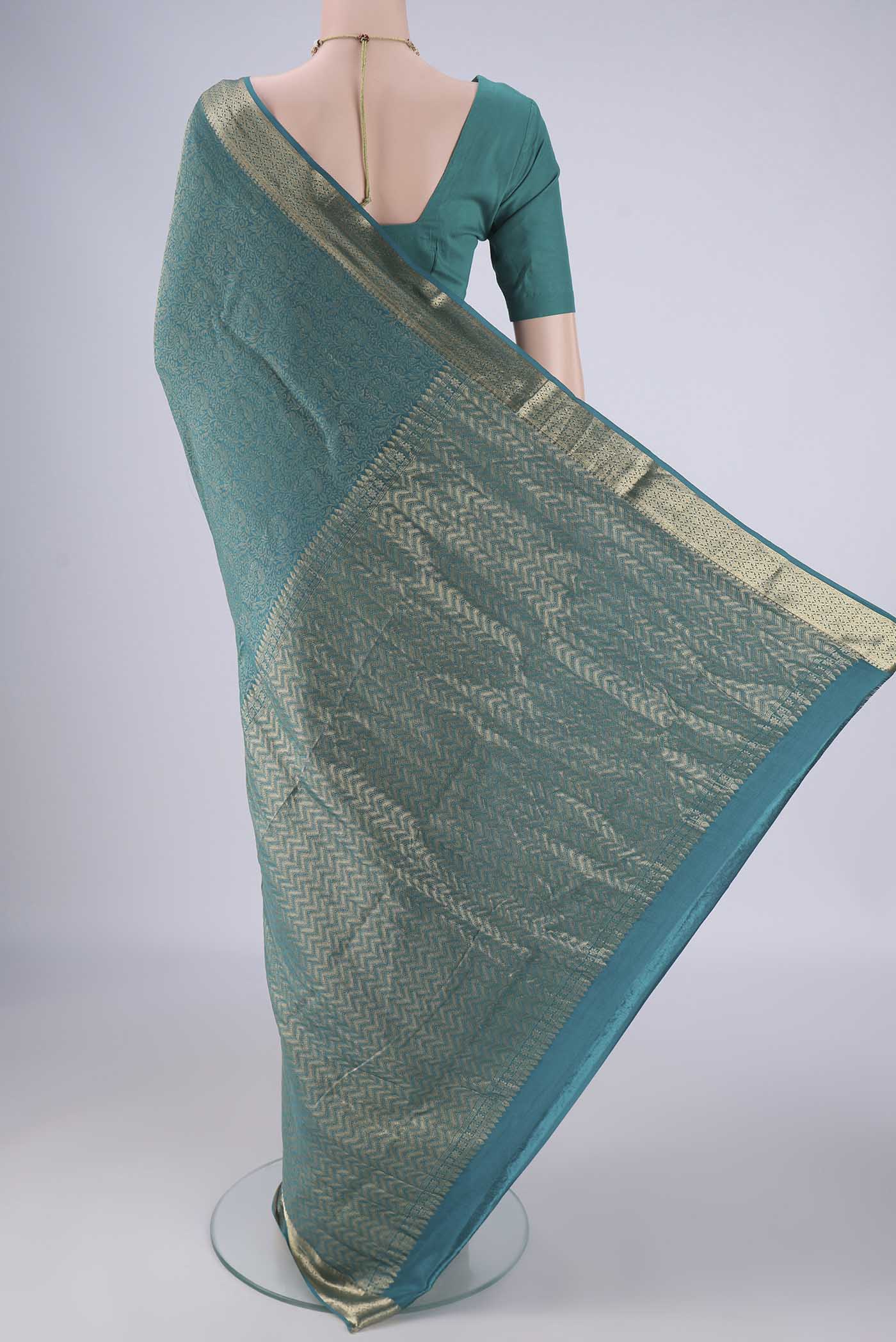Flat view of Peacock Blue Mysore Crepe Saree with Zari Brocade on the body and Zari Border. 