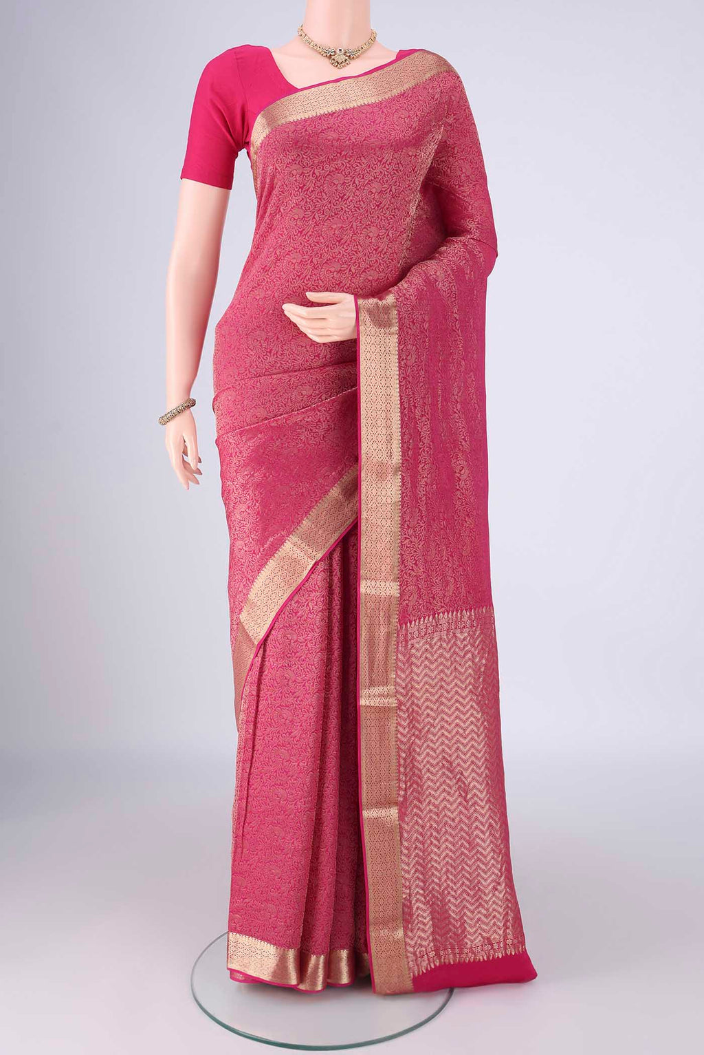 Rani Pink Mysore Crepe Saree with Zari Brocade on the body and Zari Border.  displayed on a mannequin