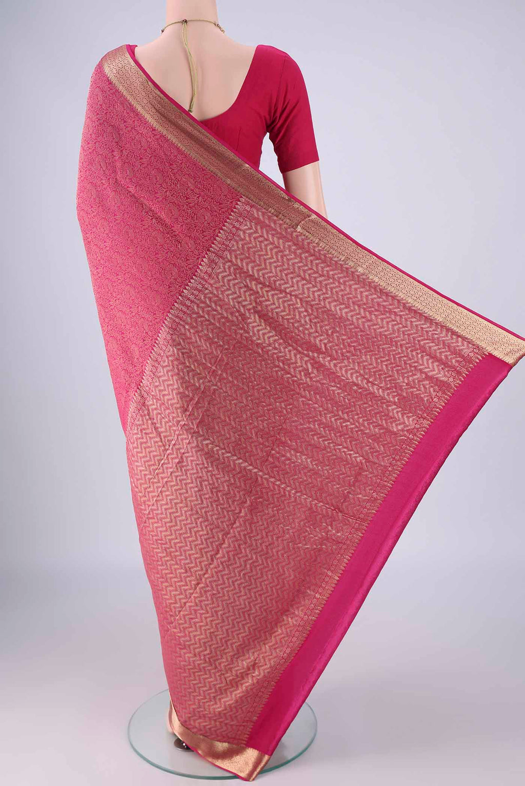 Flat view of Rani Pink Mysore Crepe Saree with Zari Brocade on the body and Zari Border. 