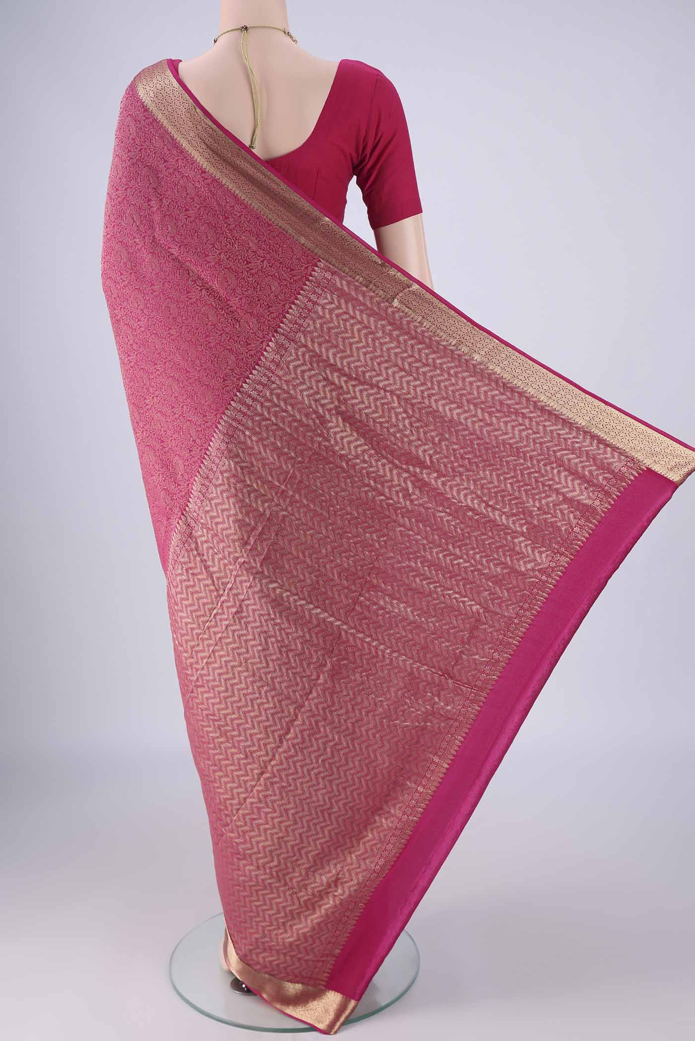 Flat view of Rani Pink Mysore Crepe Saree with Zari Brocade on the body and Zari Border. 