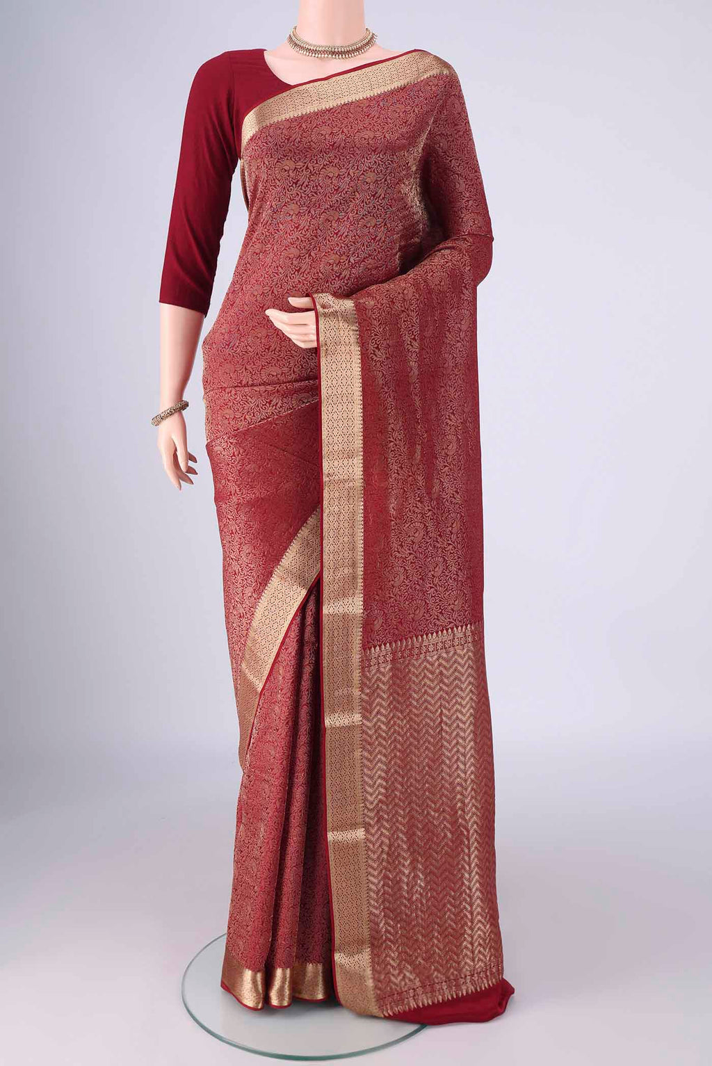 Maroon Mysore Crepe Saree with Zari Brocade on the body and Zari Border.  displayed on a mannequin
