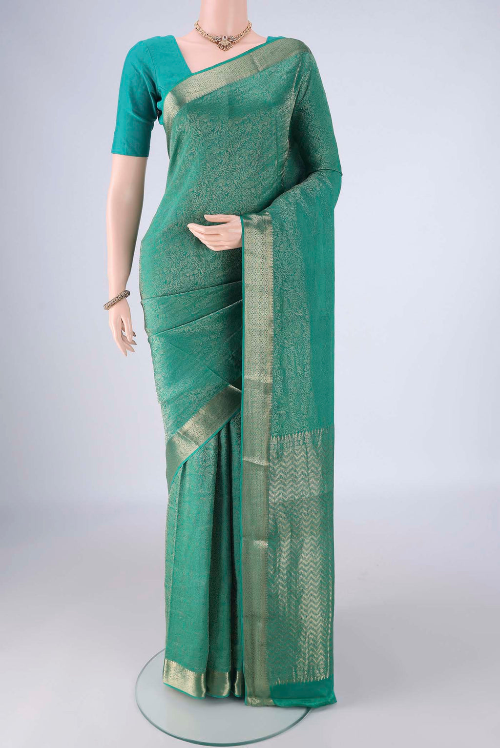 Sea Green Mysore Crepe Saree with Zari Brocade on the body and Zari Border.  displayed on a mannequin