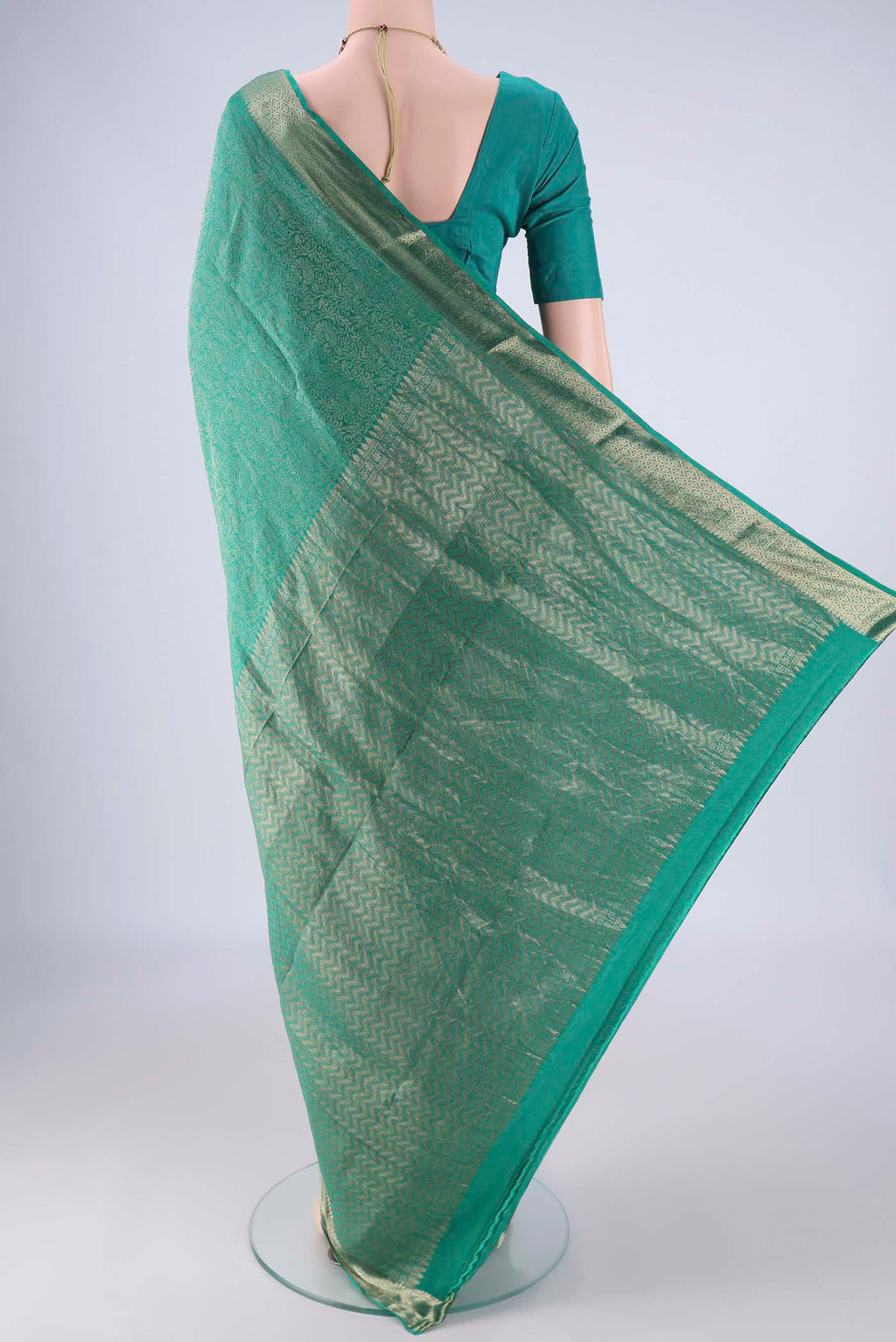 Flat view of Sea Green Mysore Crepe Saree with Zari Brocade on the body and Zari Border. 