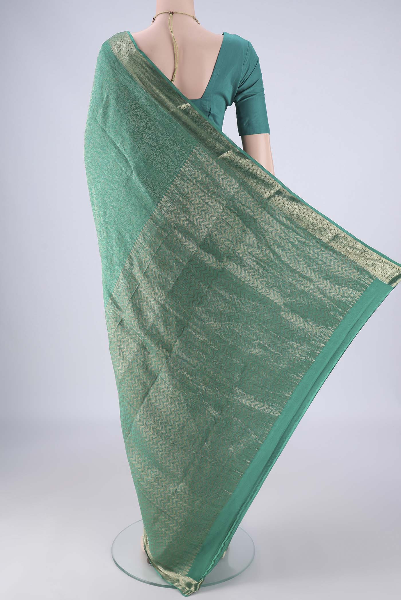 Flat view of Sea Green Mysore Crepe Saree with Zari Brocade on the body and Zari Border. 