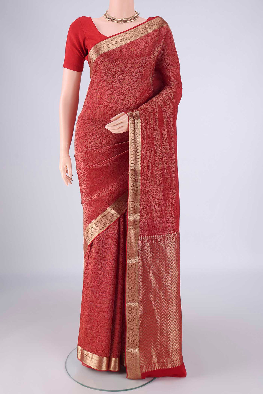 Red Mysore Crepe Saree with Zari Brocade on the body and Zari Border.  displayed on a mannequin