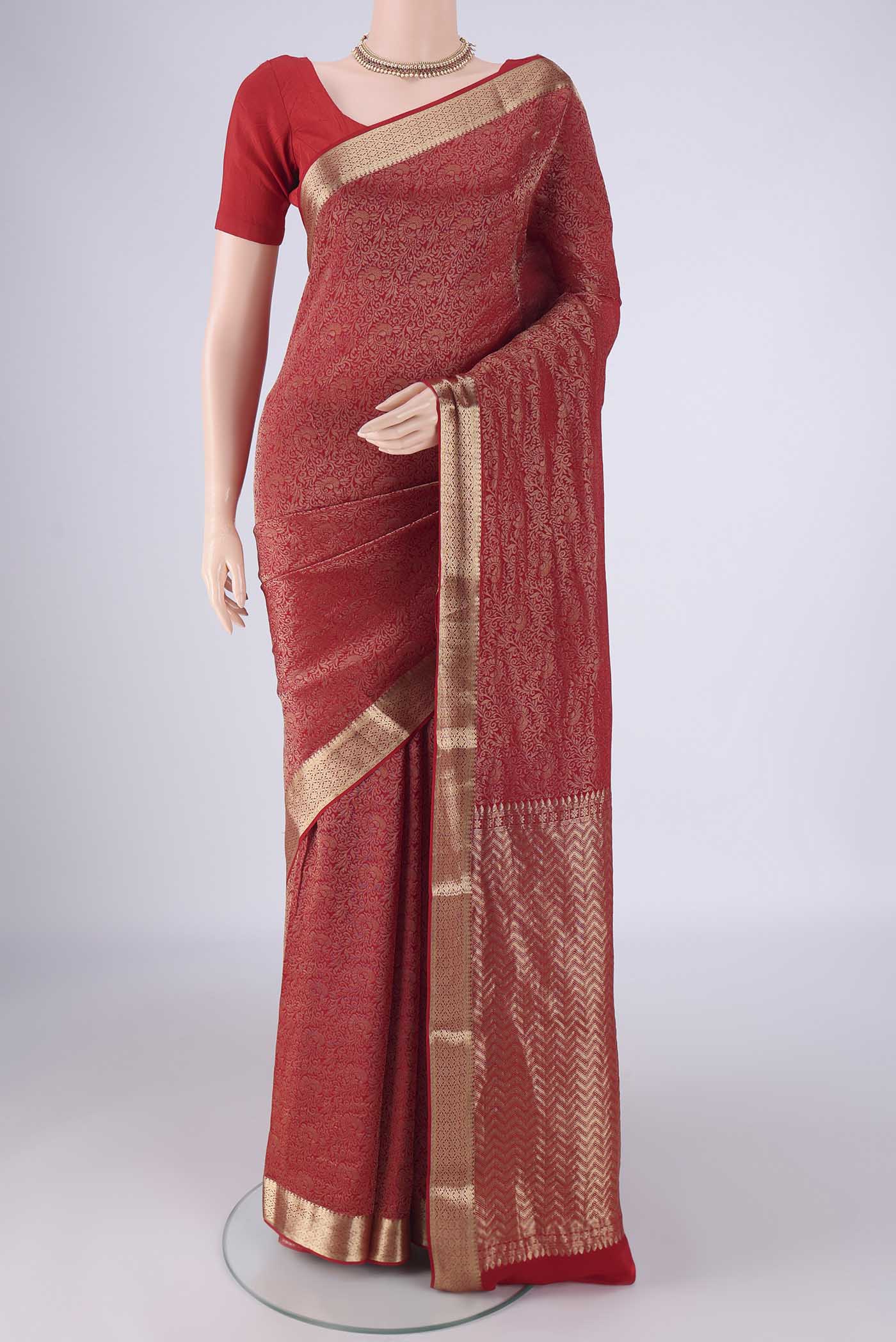 Red Mysore Crepe Saree with Zari Brocade on the body and Zari Border.  displayed on a mannequin