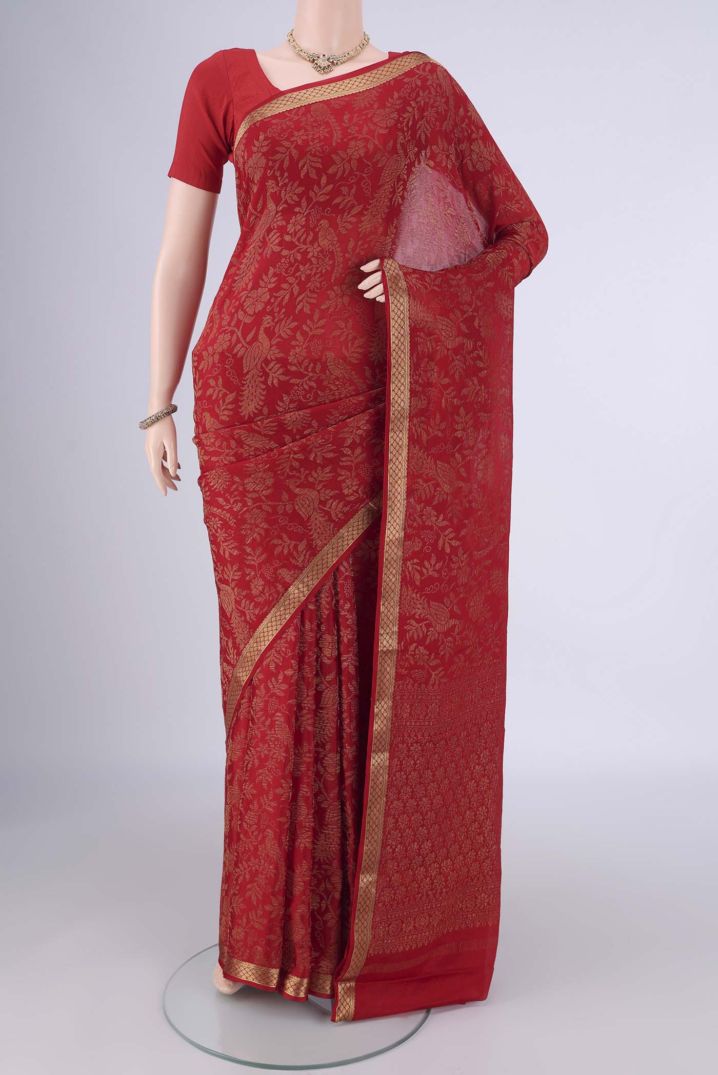 Red Mysore Crepe Saree with Zari Brocade on the body and Zari Border.  displayed on a mannequin