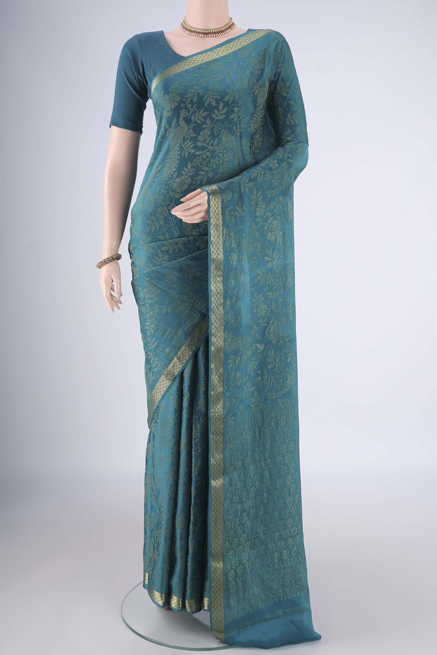 Teal Mysore Georgette Saree with Zari Brocade on the body and Zari Border.  displayed on a mannequin