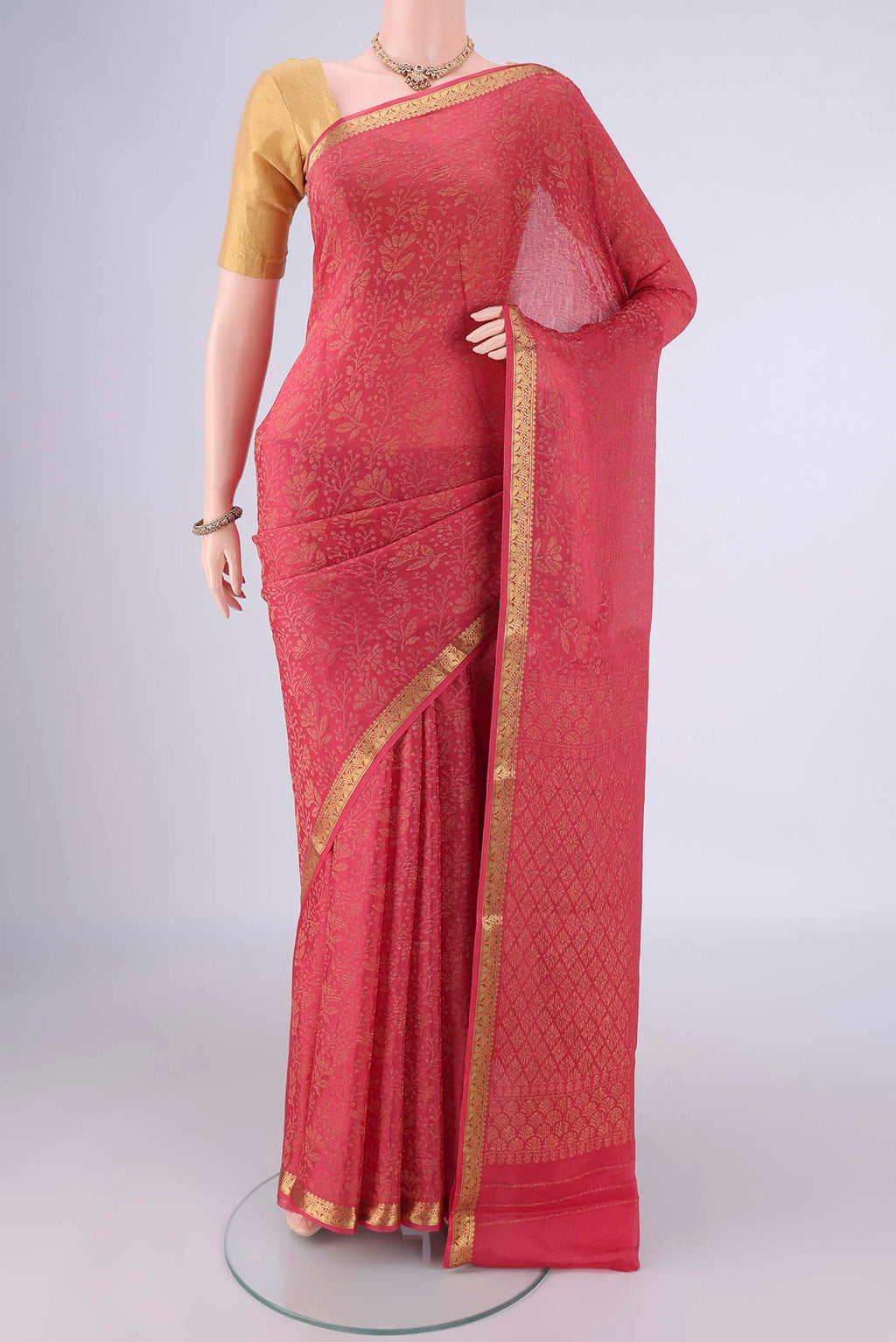 Coral Mysore Crepe Saree with Zari Brocade on the body and Zari Border.  displayed on a mannequin