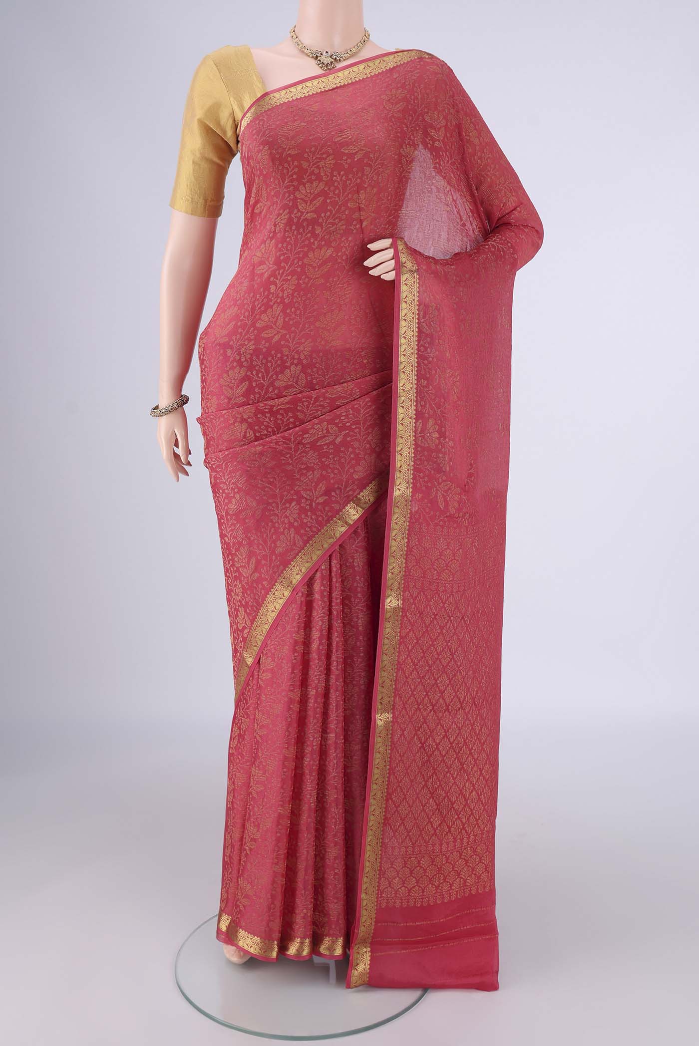 Coral Mysore Crepe Saree with Zari Brocade on the body and Zari Border.  displayed on a mannequin