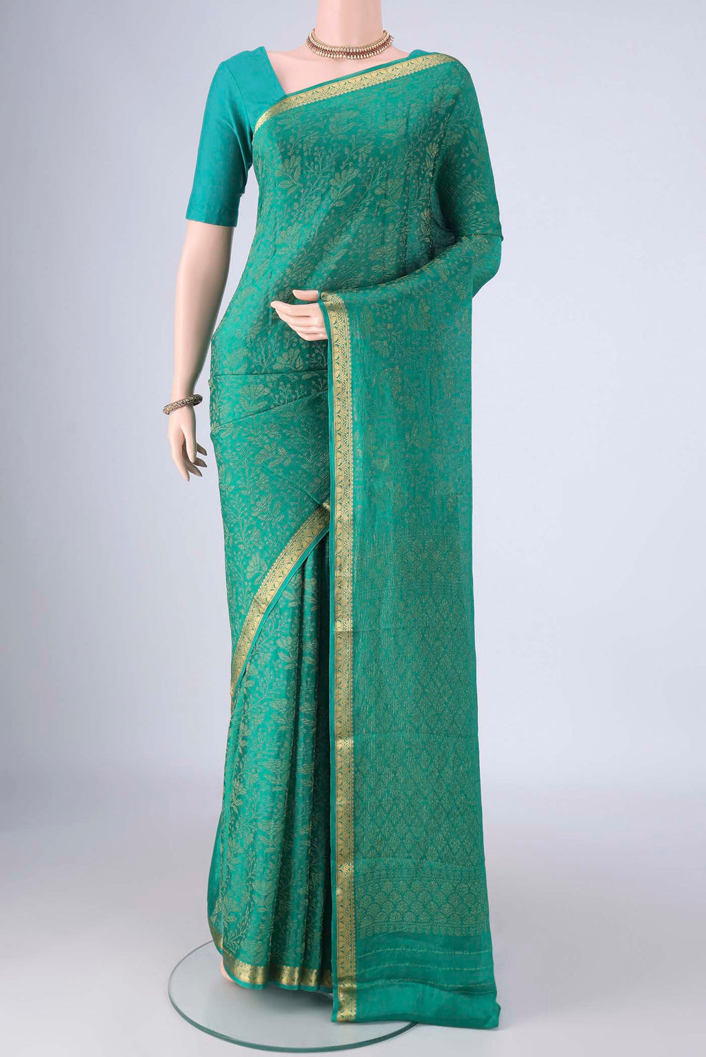 Turquoise Mysore Crepe Saree with Zari Brocade on the body and Zari Border.  displayed on a mannequin