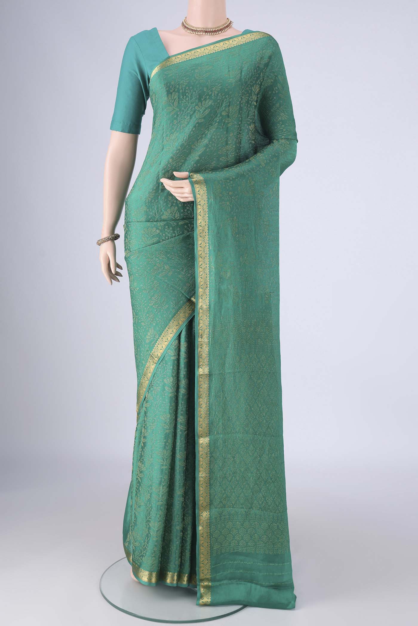 Turquoise Mysore Crepe Saree with Zari Brocade on the body and Zari Border.  displayed on a mannequin