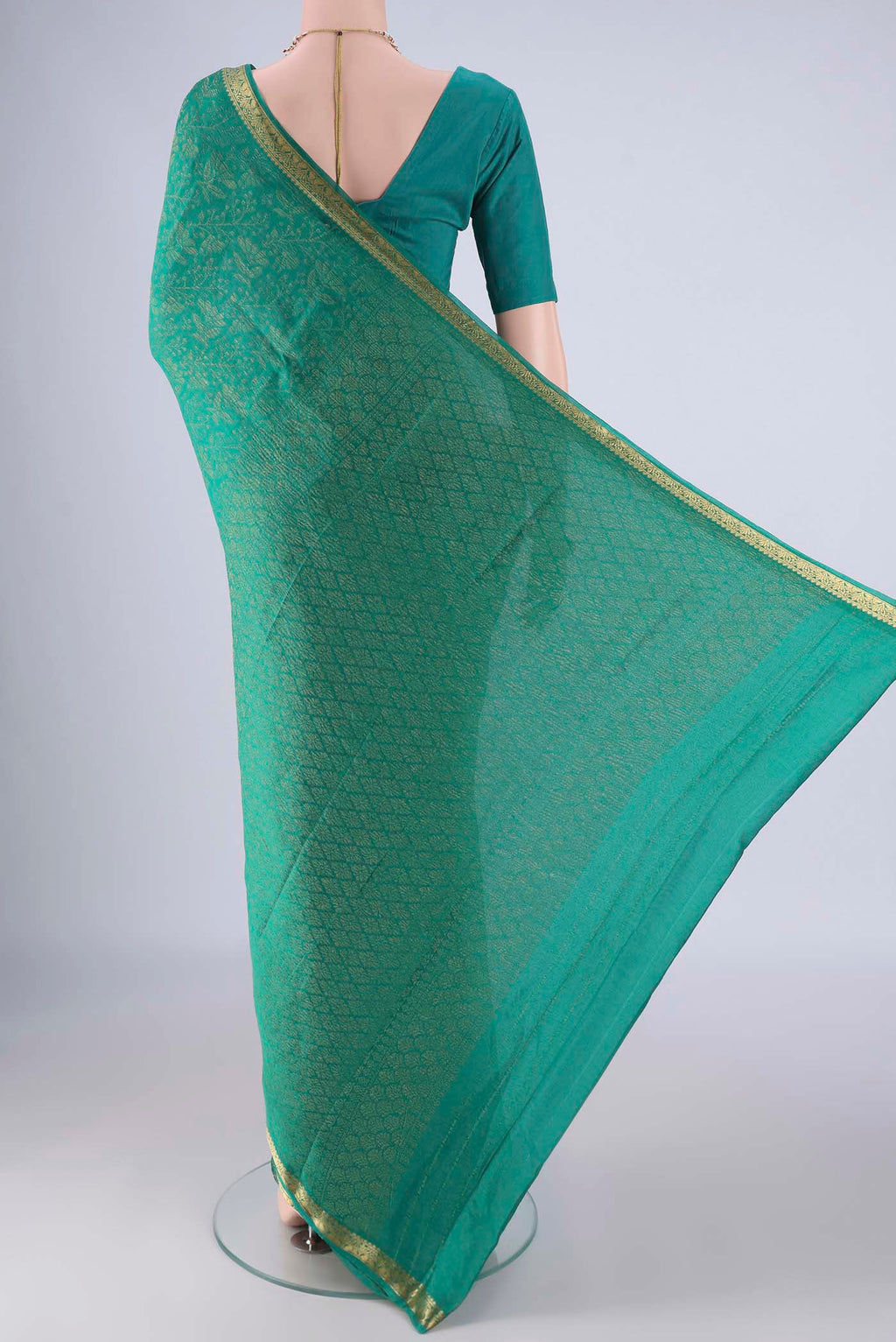 Flat view of Turquoise Mysore Crepe Saree with Zari Brocade on the body and Zari Border. 