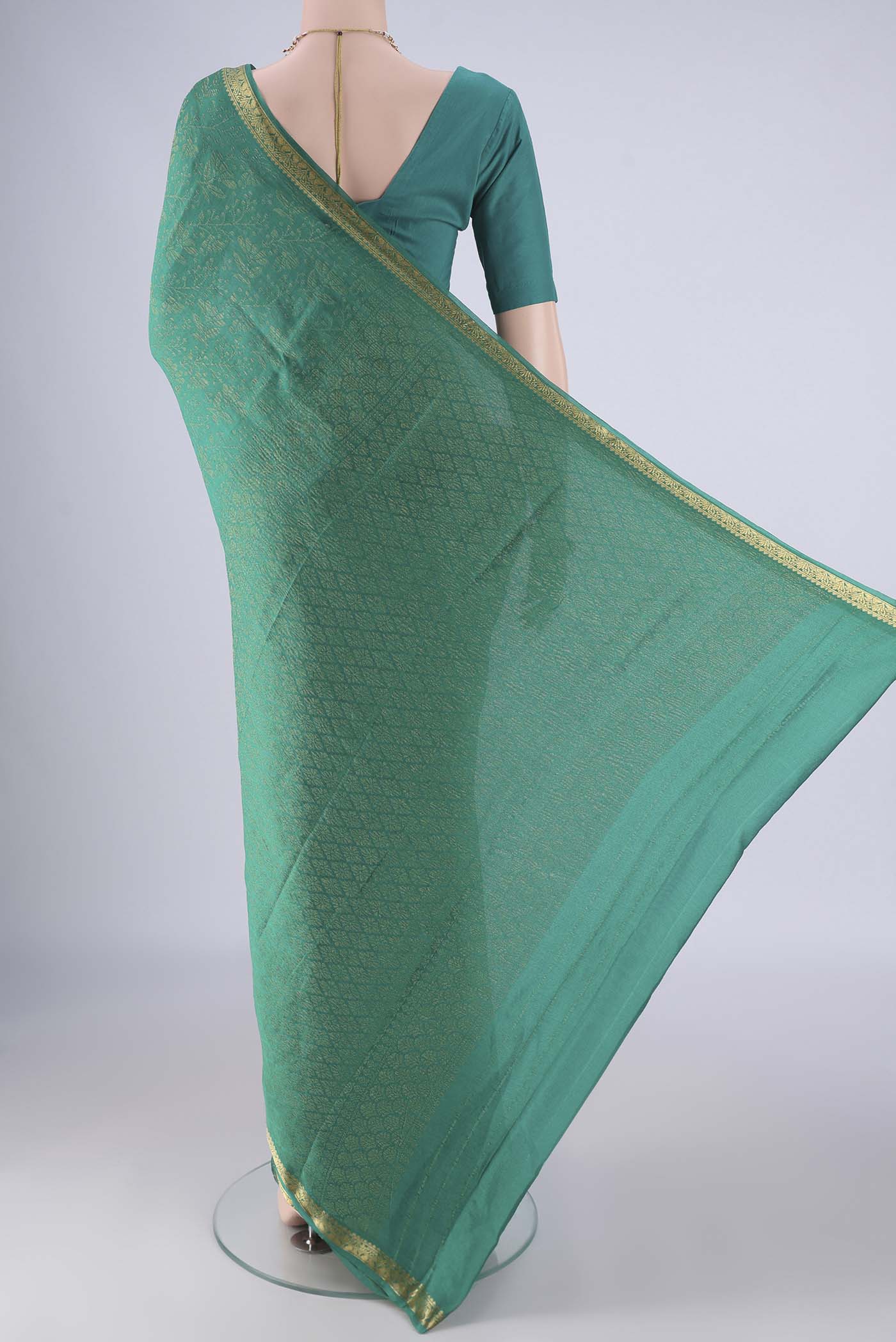 Flat view of Turquoise Mysore Crepe Saree with Zari Brocade on the body and Zari Border. 