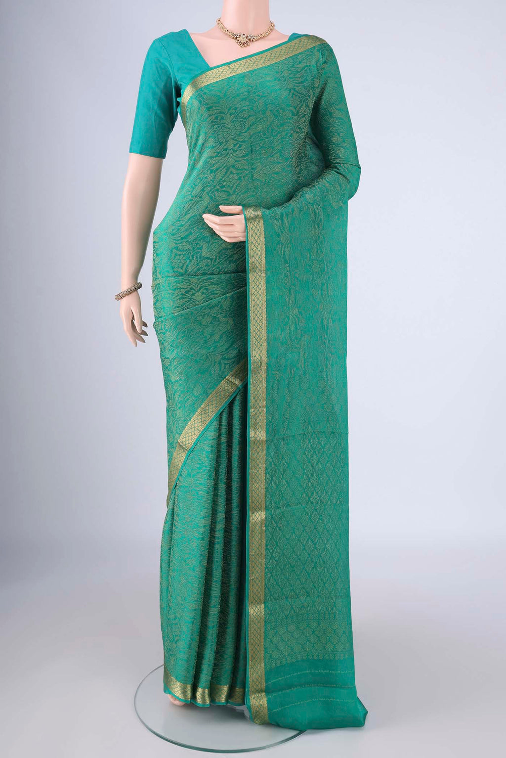 Sea Green Mysore Crepe Saree with Zari Brocade on the body and Zari Border.  displayed on a mannequin