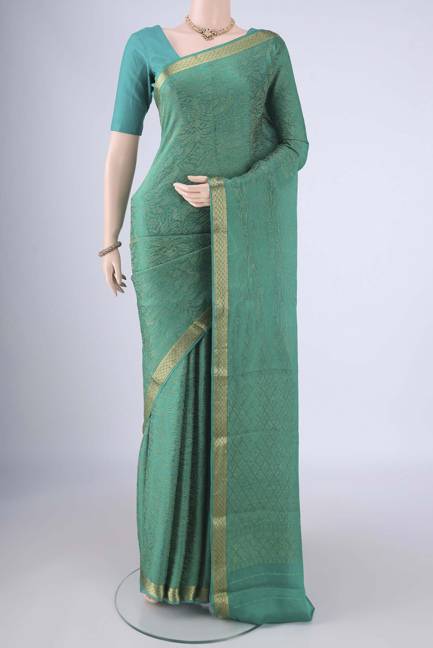 Sea Green Mysore Crepe Saree with Zari Brocade on the body and Zari Border.  displayed on a mannequin