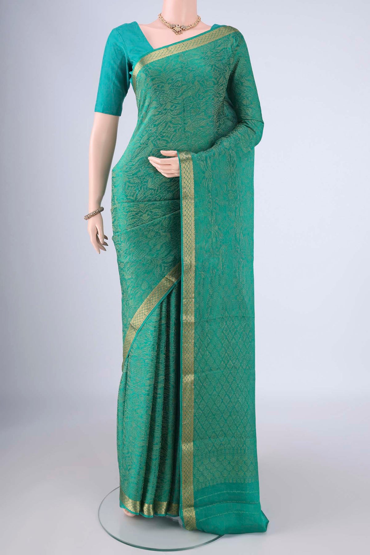 Sea Green Mysore Crepe Saree with Zari Brocade on the body and Zari Border.  displayed on a mannequin