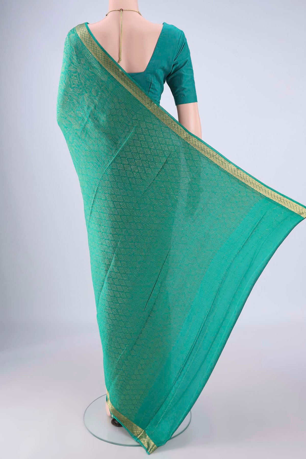 Flat view of Sea Green Mysore Crepe Saree with Zari Brocade on the body and Zari Border. 