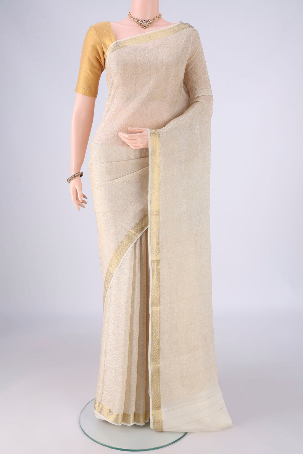 Off White Mysore Crepe Saree with Zari Brocade on the body and Zari Border.  displayed on a mannequin