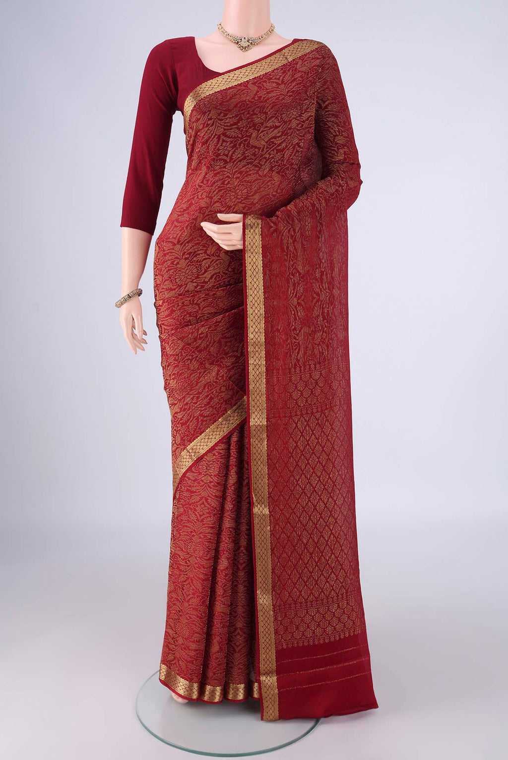 Maroon Mysore Crepe Saree with Zari Brocade on the body and Zari Border.  displayed on a mannequin