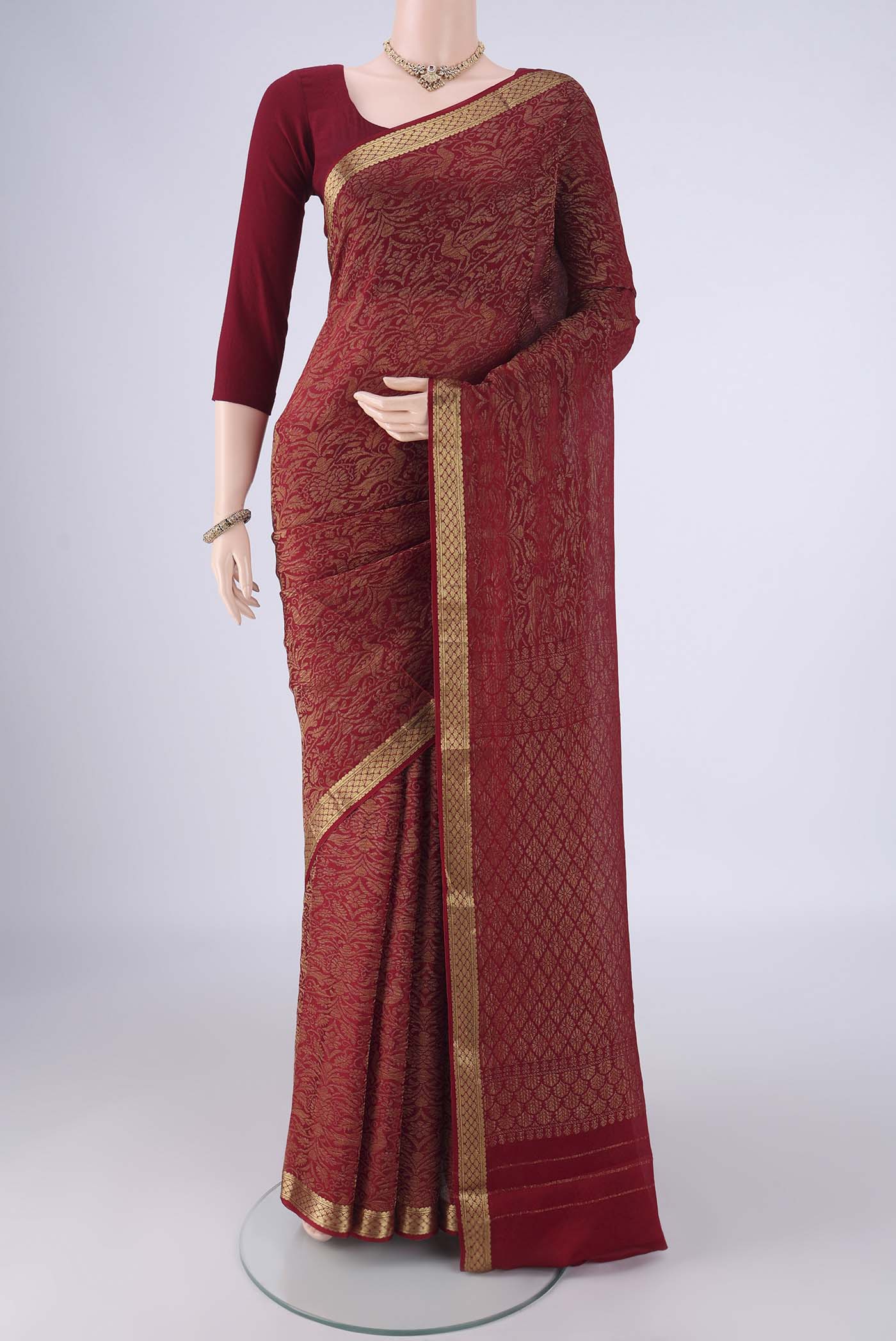 Maroon Mysore Crepe Saree with Zari Brocade on the body and Zari Border.  displayed on a mannequin