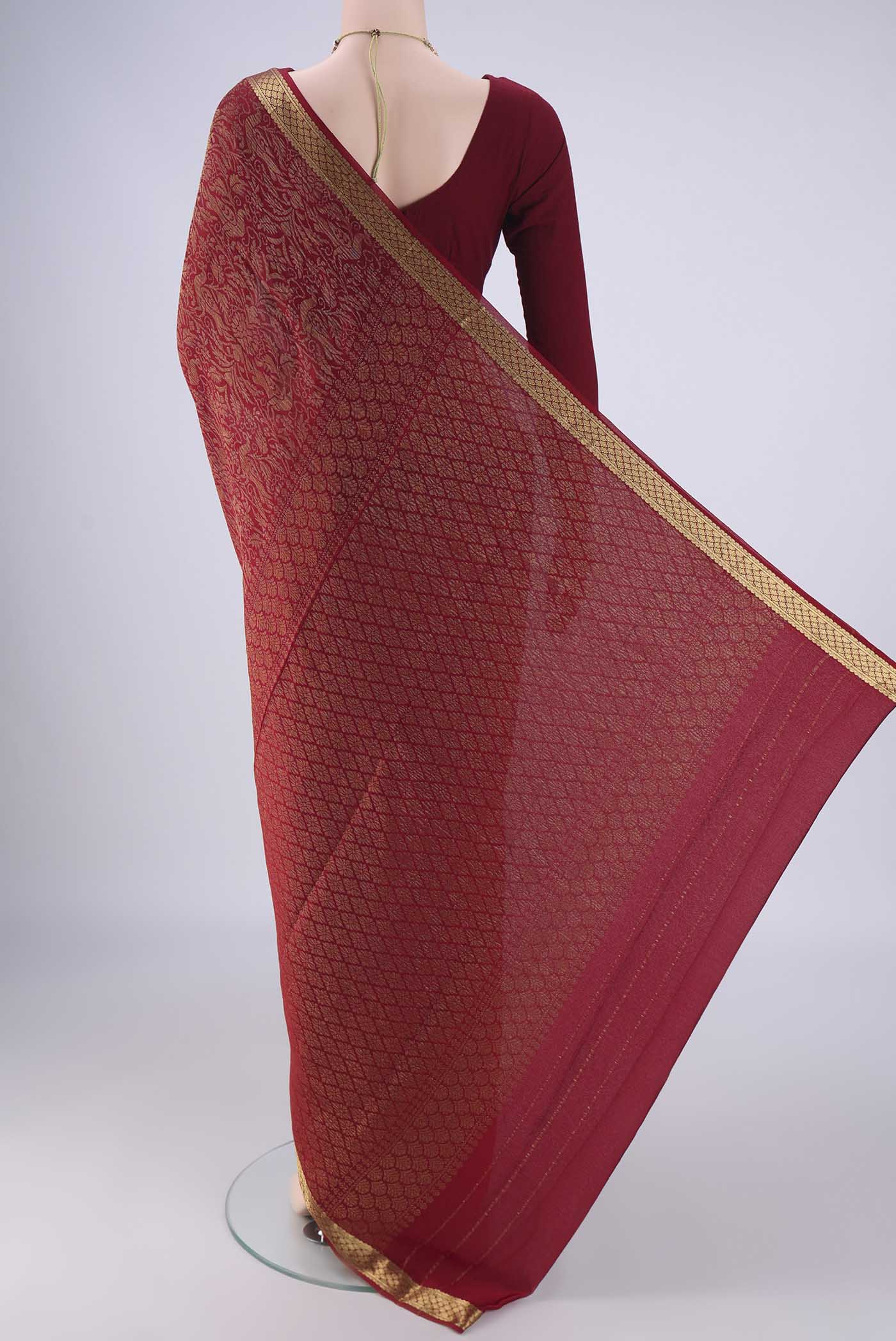 Flat view of Maroon Mysore Crepe Saree with Zari Brocade on the body and Zari Border. 