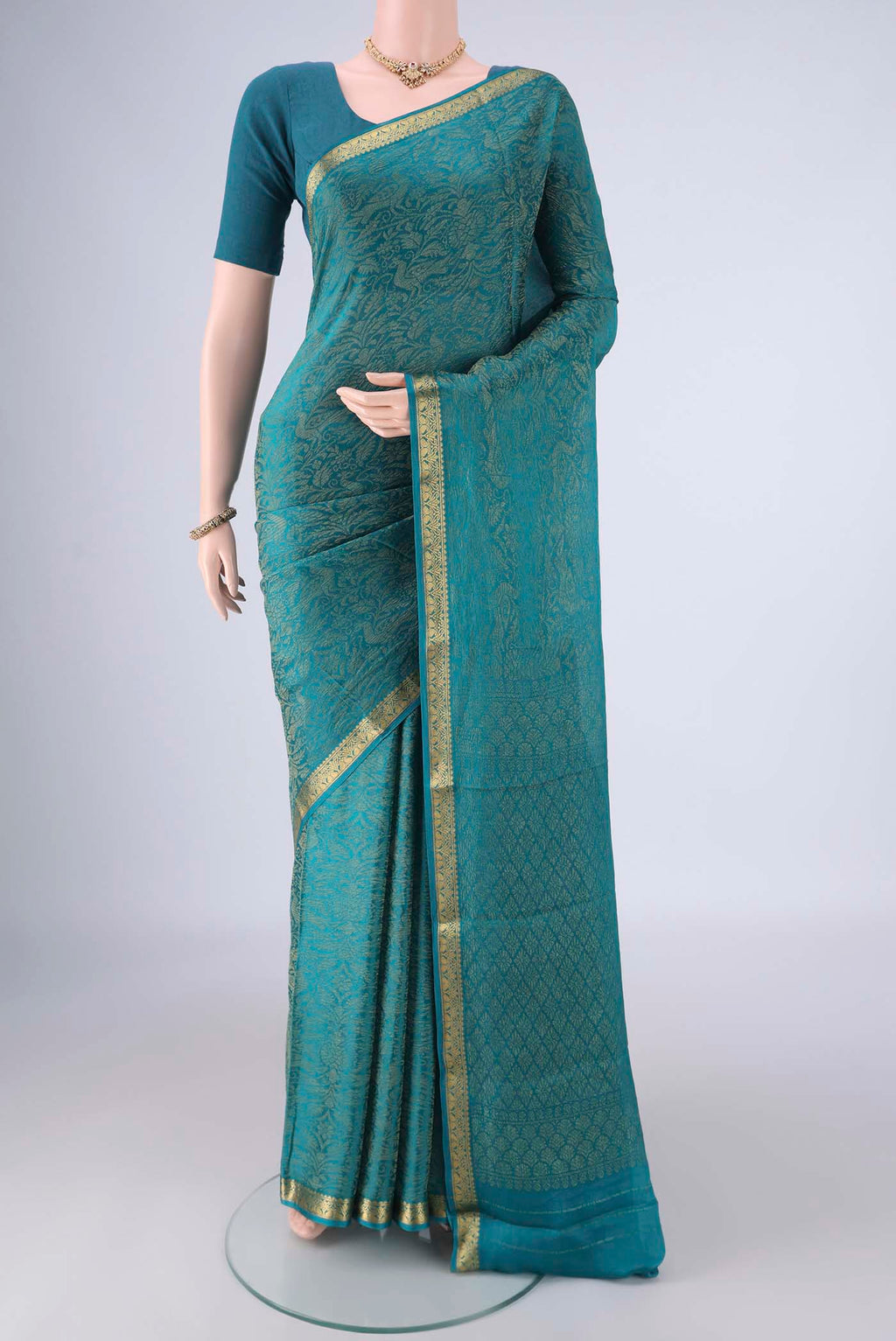 Teal Mysore Crepe Saree with Zari Brocade on the body and Zari Border.  displayed on a mannequin